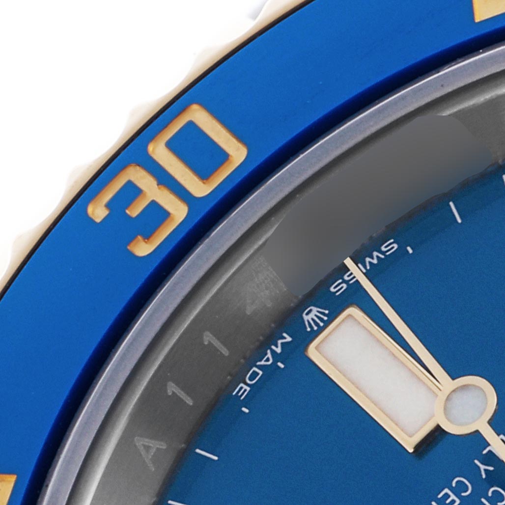 The image shows a close-up of a Rolex Submariner 126613LB Men's Steel and Gold (two tone) Blue Dial 126613LB Men's Steel and Gold (two tone) Blue Dial's blue bezel and dial with part of the minute hand.