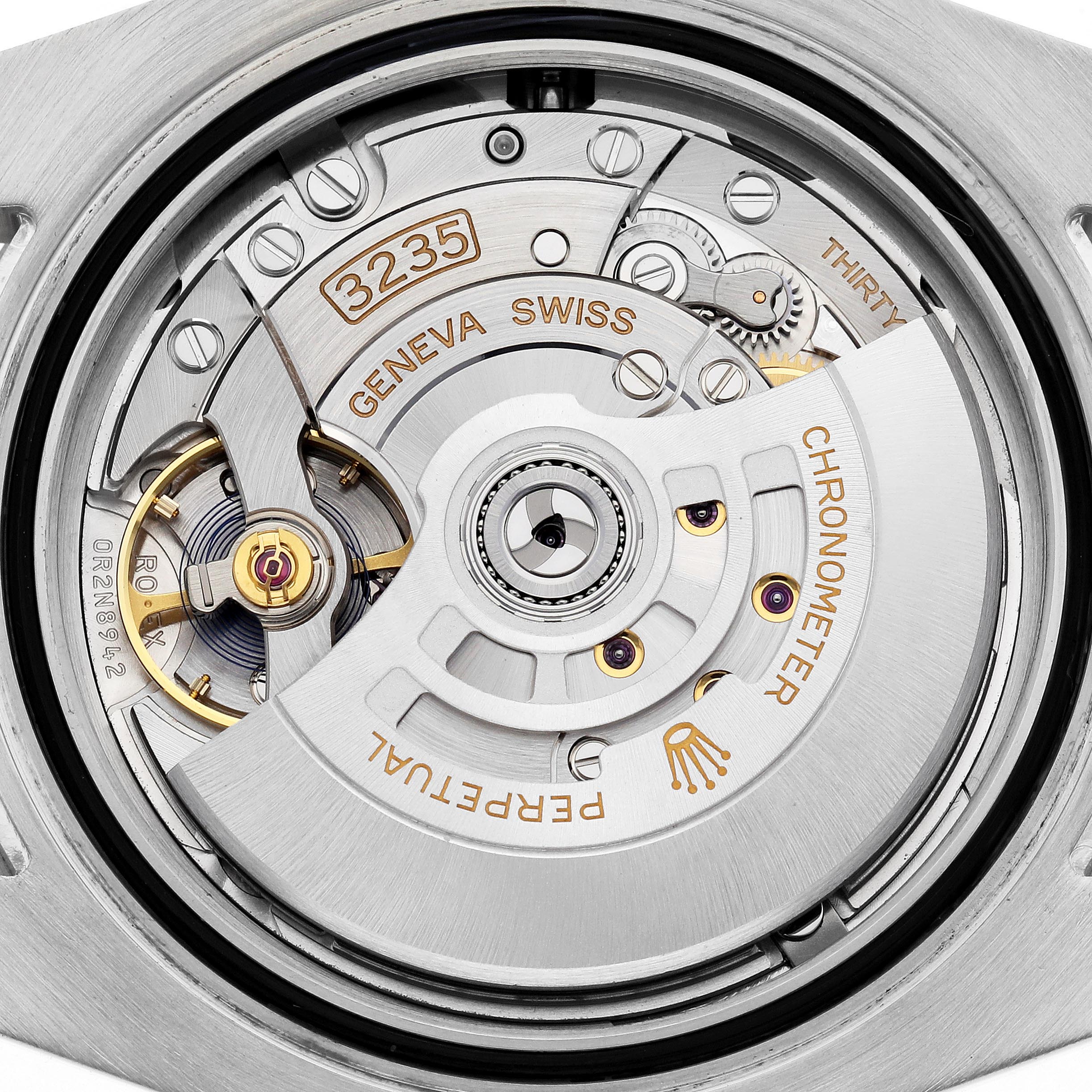 The image shows a close-up view of the Rolex Submariner 126613LB Men's Steel and Gold (two tone) Blue Dial 126613LB Men's Steel and Gold (two tone) Blue Dial's movement, highlighting the intricate gears and rotor marked "Perpetual" and "Chronometer."