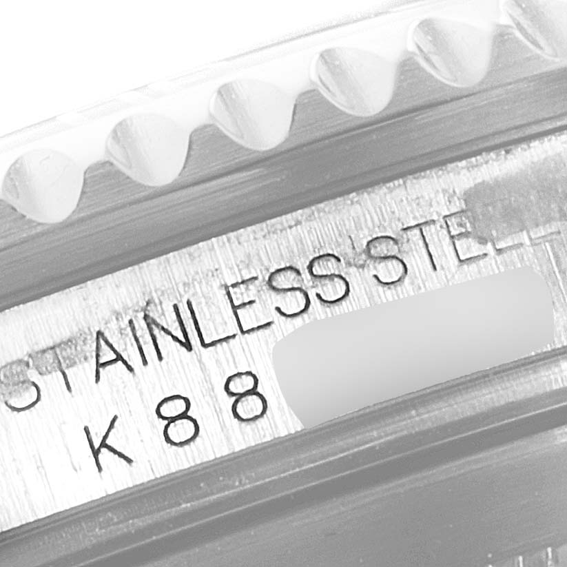 Close-up of the side engraving and bezel of a Rolex Submariner 16610 Men
s Stainless Steel Black Dial 16610 Men
s Stainless Steel Black Dial watch, showing "STAINLESS STEEL" and part of the serial number.