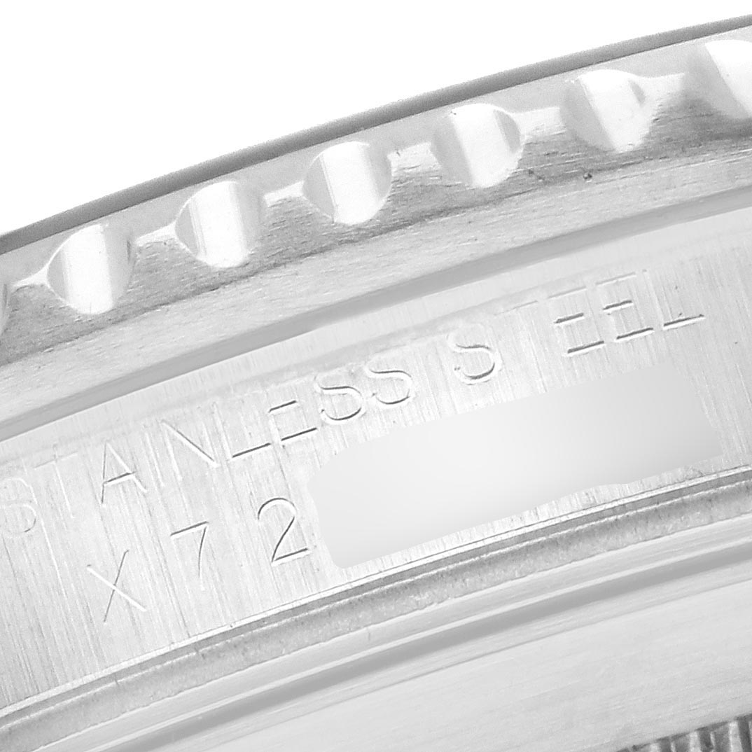 The image shows the edge and part of the engraved case of a Rolex Submariner 16610 Men's Stainless Steel Black Dial 16610 Men's Stainless Steel Black Dial, displaying the "STAINLESS STEEL" marking.