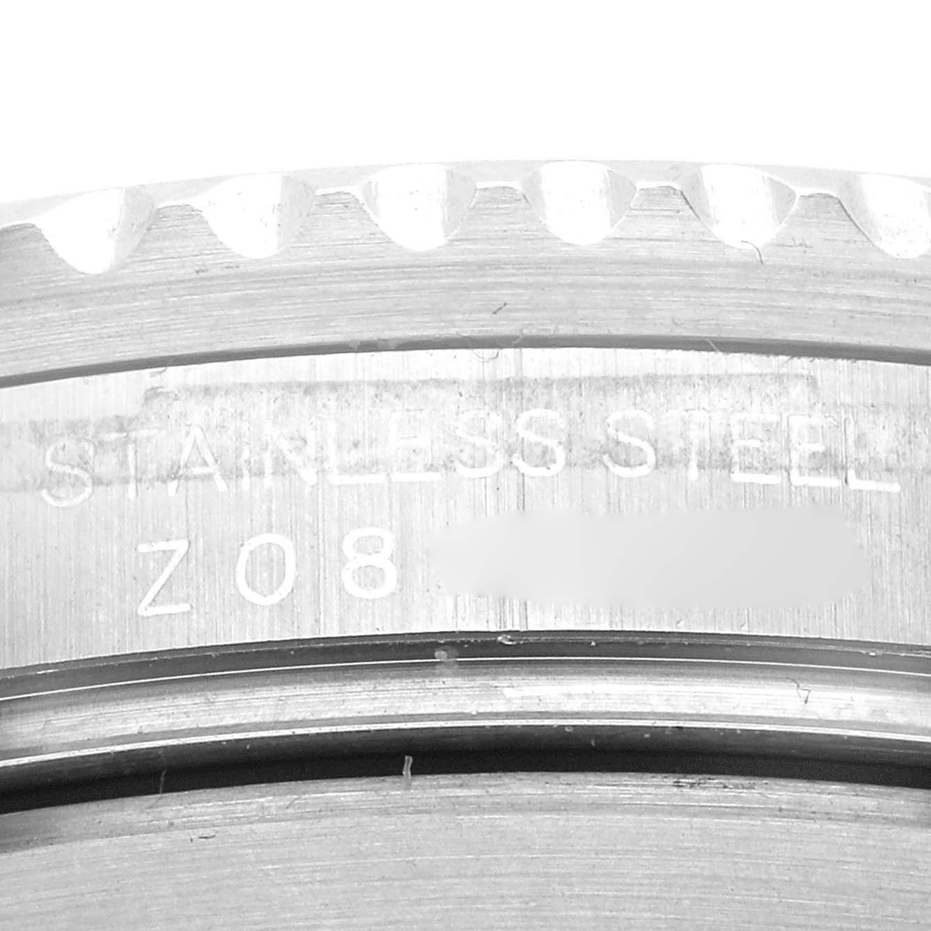 This close-up image shows the engraving on the side of the stainless steel bezel of a Rolex Submariner 16610 Men
s Stainless Steel Black Dial 16610 Men
s Stainless Steel Black Dial watch.