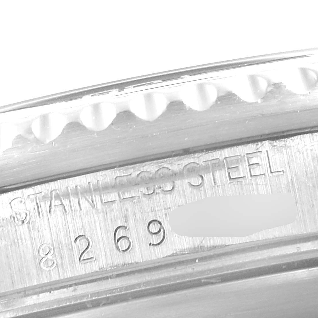 This image shows a close-up view of the stainless steel part and serial number of the Rolex Vintage Collection 16800 Men's Stainless Steel Black Dial 16800 Men's Stainless Steel Black Dial watch.