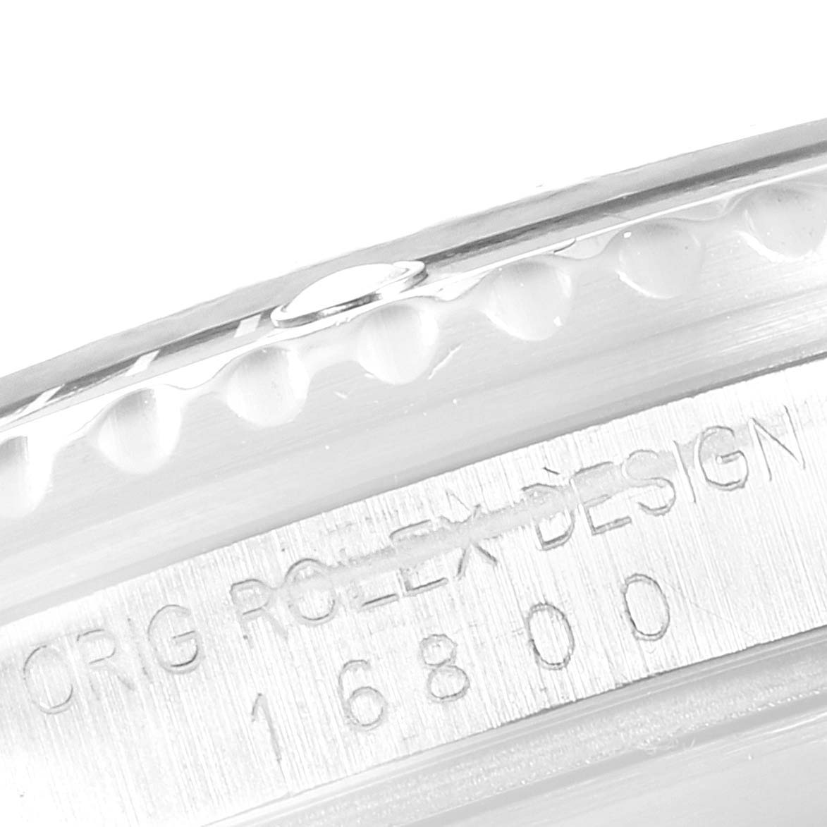 The image shows a close-up of the serial number and "ORG ROLEX DESIGN" engraving on the side of a Vintage Collection Rolex watch.