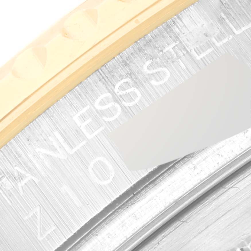 This image shows a close-up of the engraved bezel and stainless steel parts of the Rolex Yacht-Master 16623 Men
s Steel and Gold (two tone) White Dial 16623 Men
s Steel and Gold (two tone) White Dial watch.