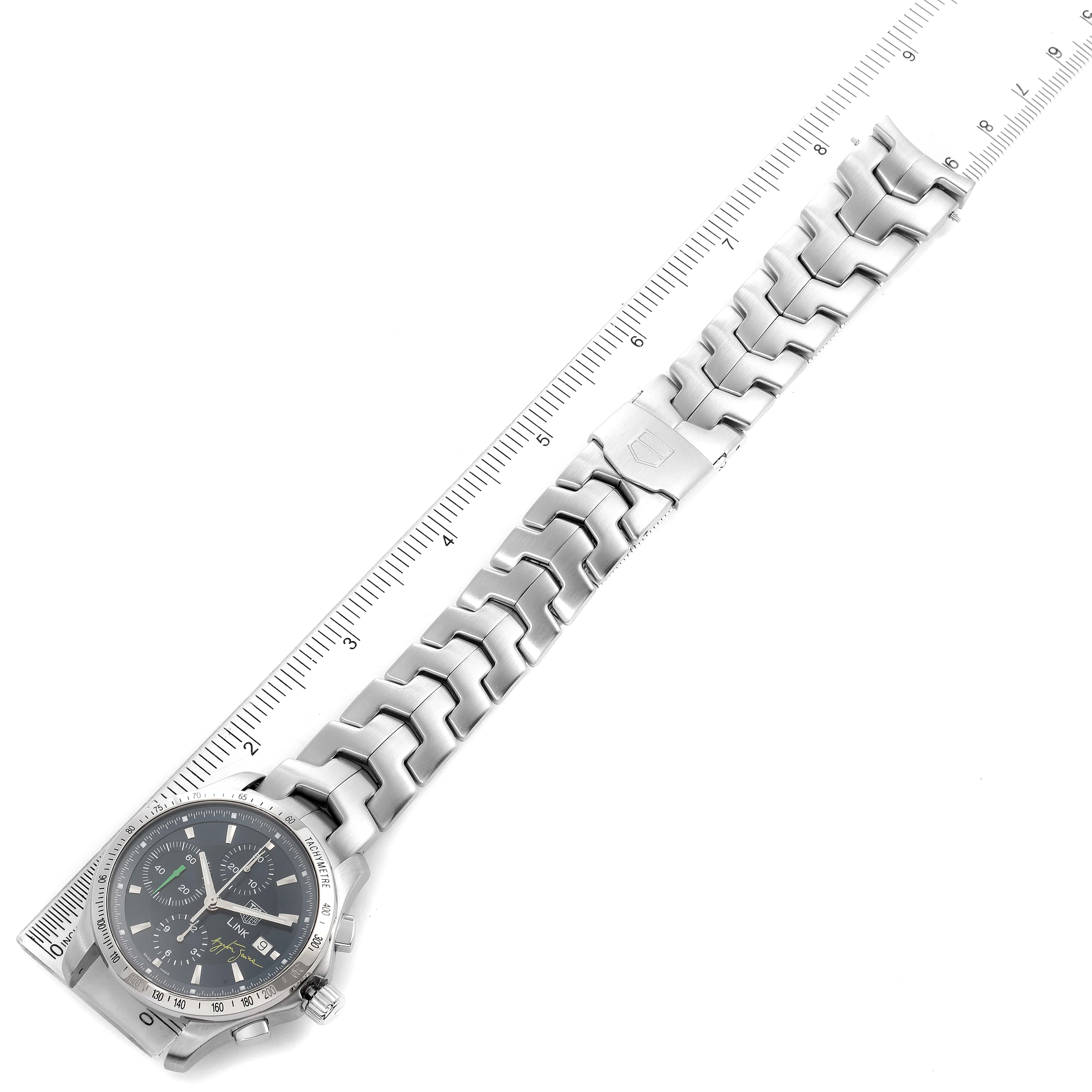 The image shows a top-down view of a Tag Heuer Link model watch with its metal bracelet and part of a ruler.