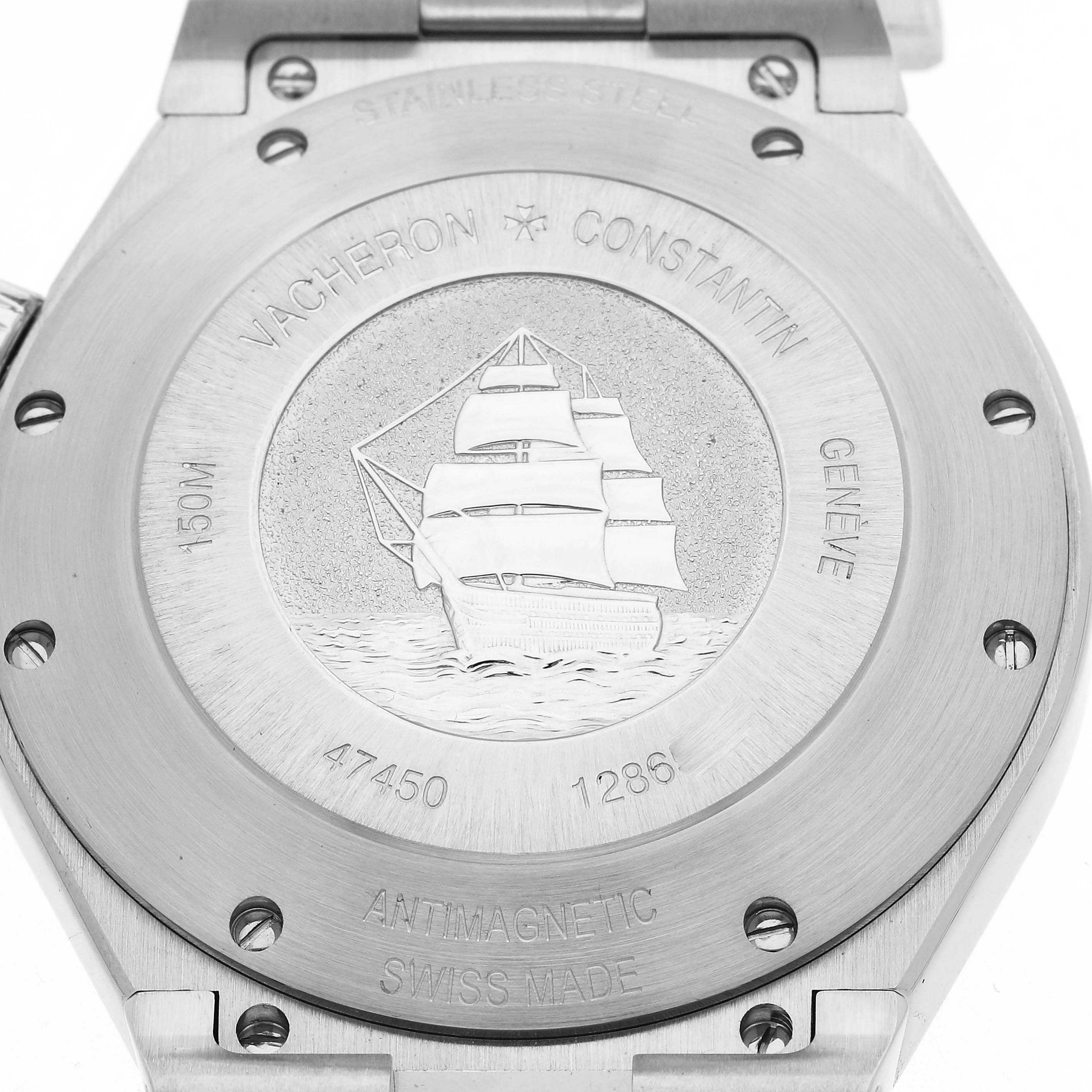 The image shows the case back of the Vacheron Constantin Overseas 47450/B01A-9226 Men's Stainless Steel Silver Dial 47450/B01A-9226 Men's Stainless Steel Silver Dial model, featuring an engraved ship and various inscriptions.
