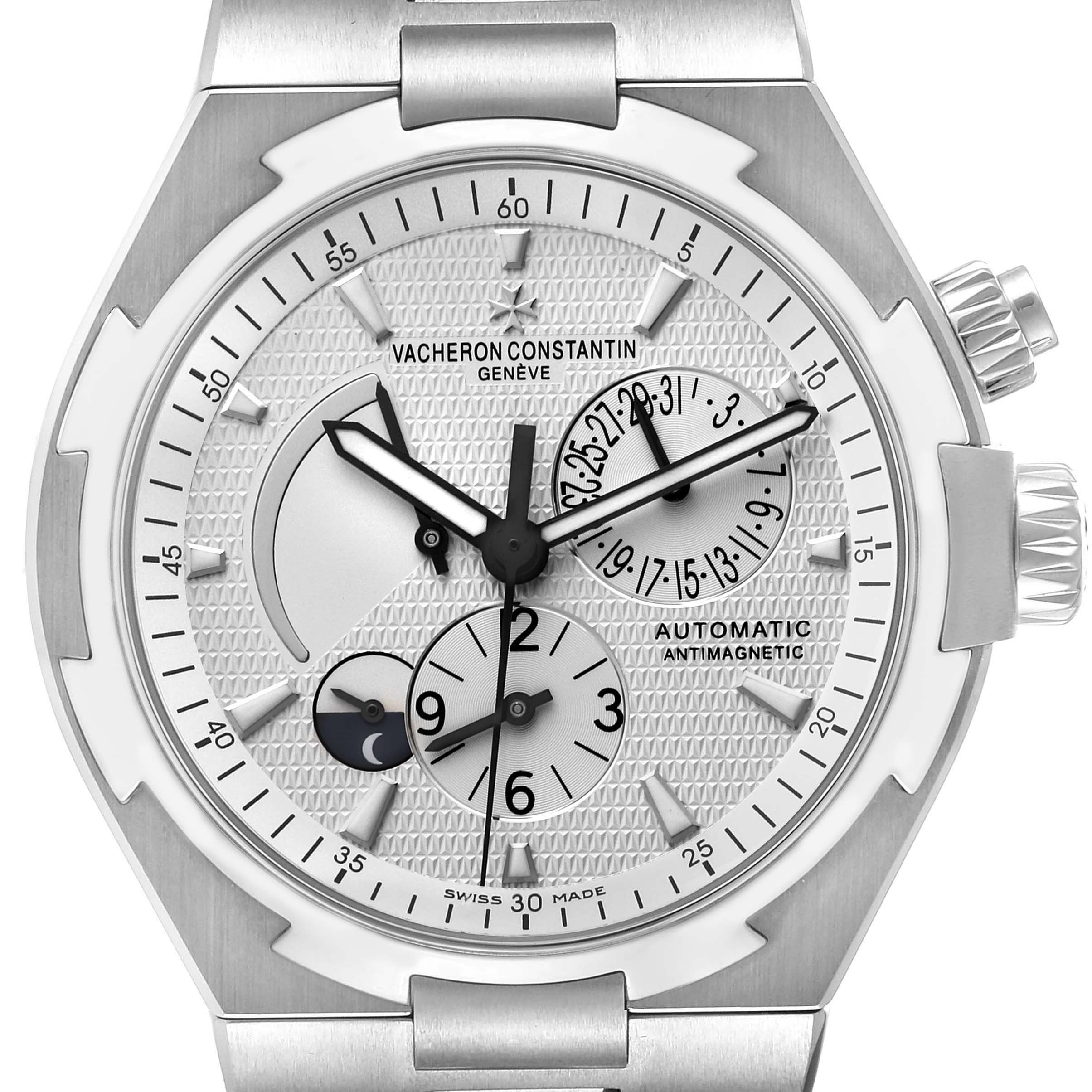 The Vacheron Constantin Overseas 47450/B01A-9226 Men's Stainless Steel Silver Dial 47450/B01A-9226 Men's Stainless Steel Silver Dial watch is shown from a frontal angle, highlighting the dial, sub-dials, and crowns.
