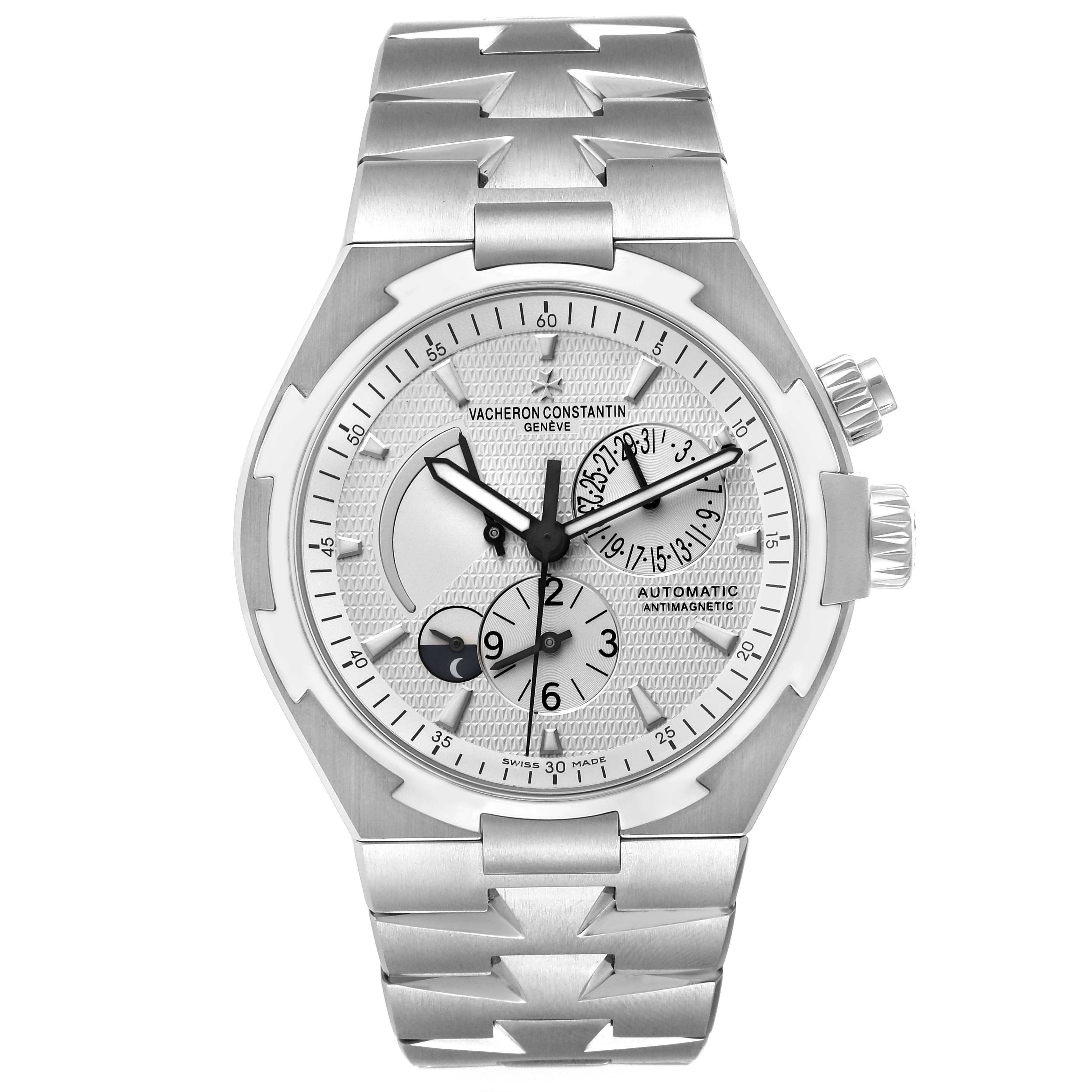 The Vacheron Constantin Overseas 47450/B01A-9226 Men's Stainless Steel Silver Dial 47450/B01A-9226 Men's Stainless Steel Silver Dial watch is shown from a front angle, displaying its dial, bezel, and bracelet.