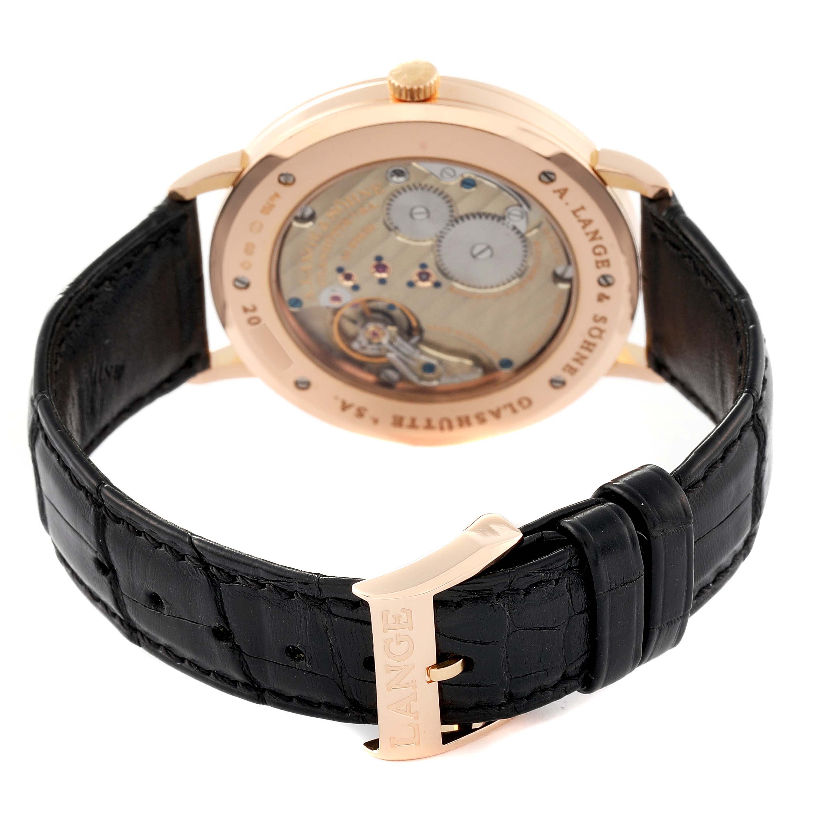 This image shows the back view of the A. Lange 
Sohne Saxonia 211.032 Men
s Rose Gold Silver Dial watch, displaying the movement and black leather strap.