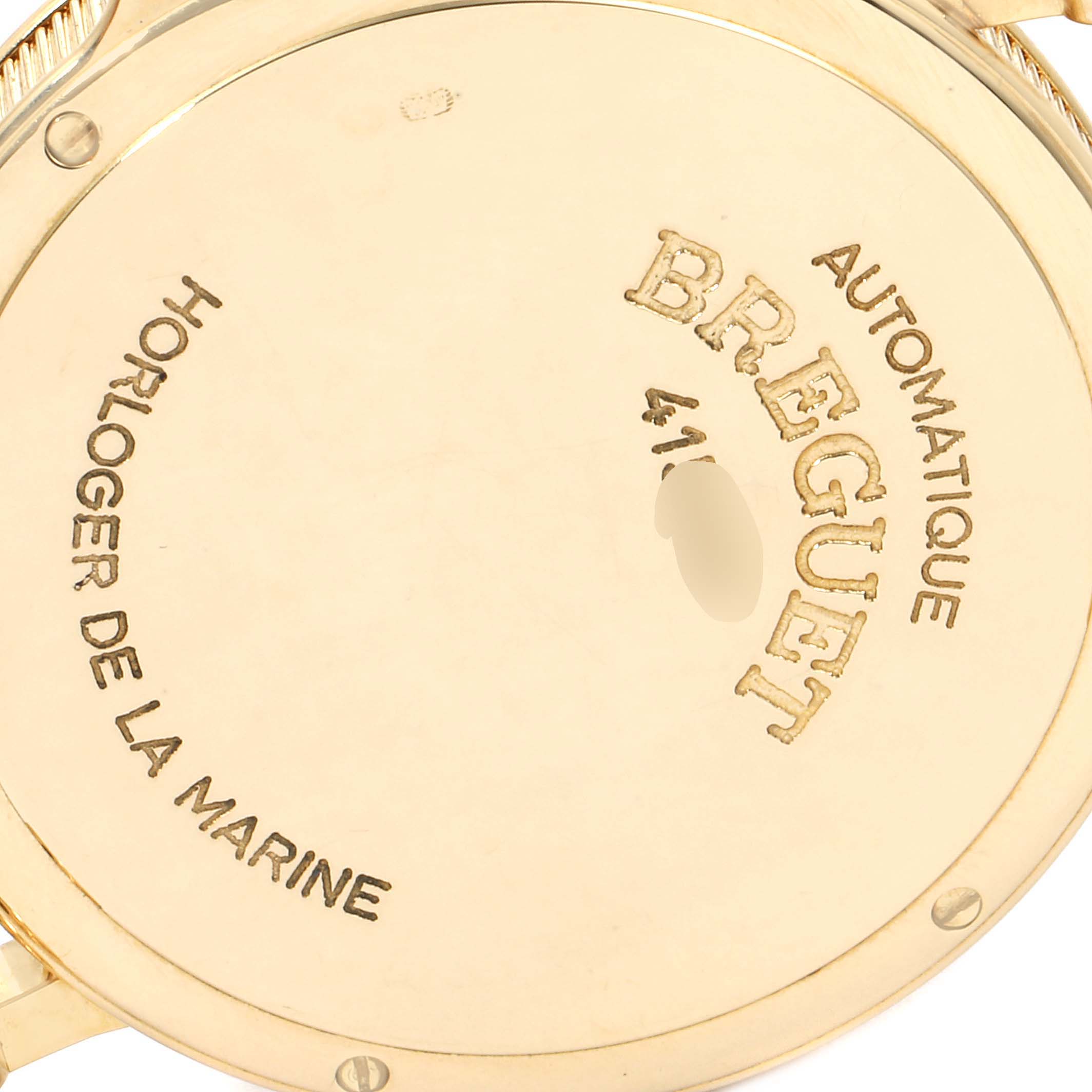 This image shows the back case of the Breguet Classique 4154G Men's Yellow Gold Silver Dial 4154G Men's Yellow Gold Silver Dial watch at a slightly tilted angle, highlighting engravings and screws.