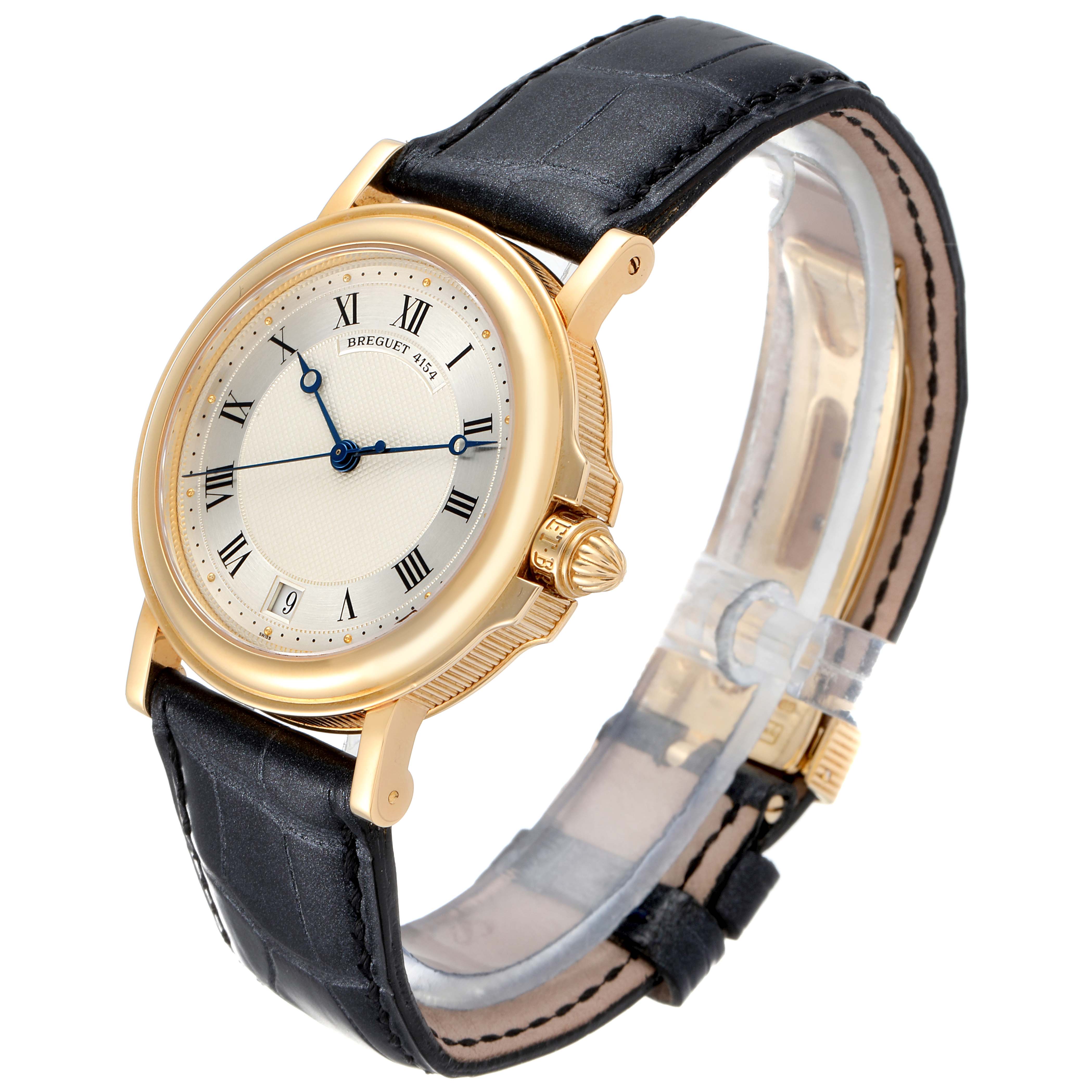This image shows a side angle view of the Breguet Classique 4154G Men's Yellow Gold Silver Dial 4154G Men's Yellow Gold Silver Dial watch, including its face, bezel, crown, and leather strap.