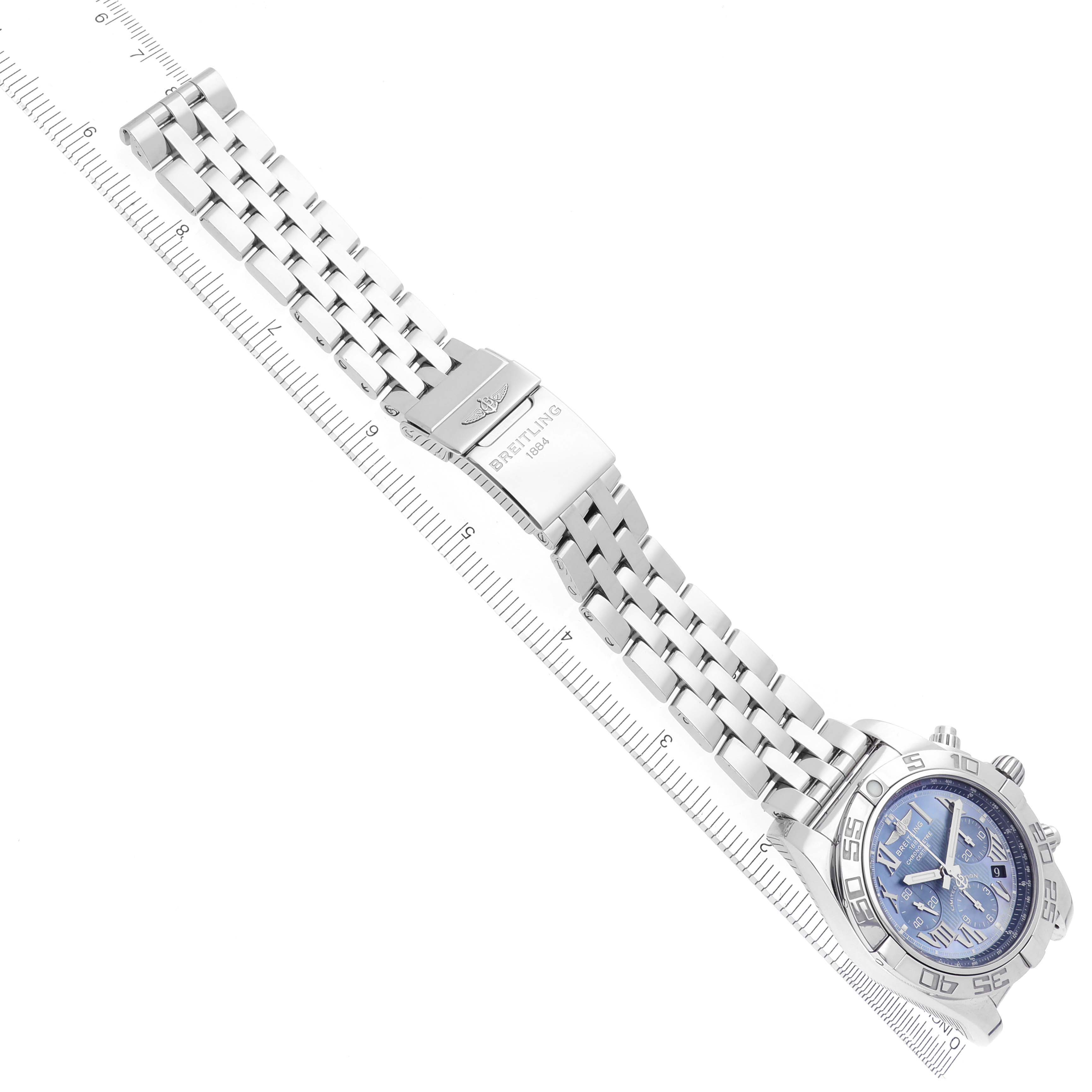 The image shows a Breitling Chronomat AB0110 Men's Stainless Steel Mother of Pearl Dial AB0110 Men's Stainless Steel Mother of Pearl Dial watch from an angled top view, featuring a metal bracelet and clasp alongside a visible ruler.