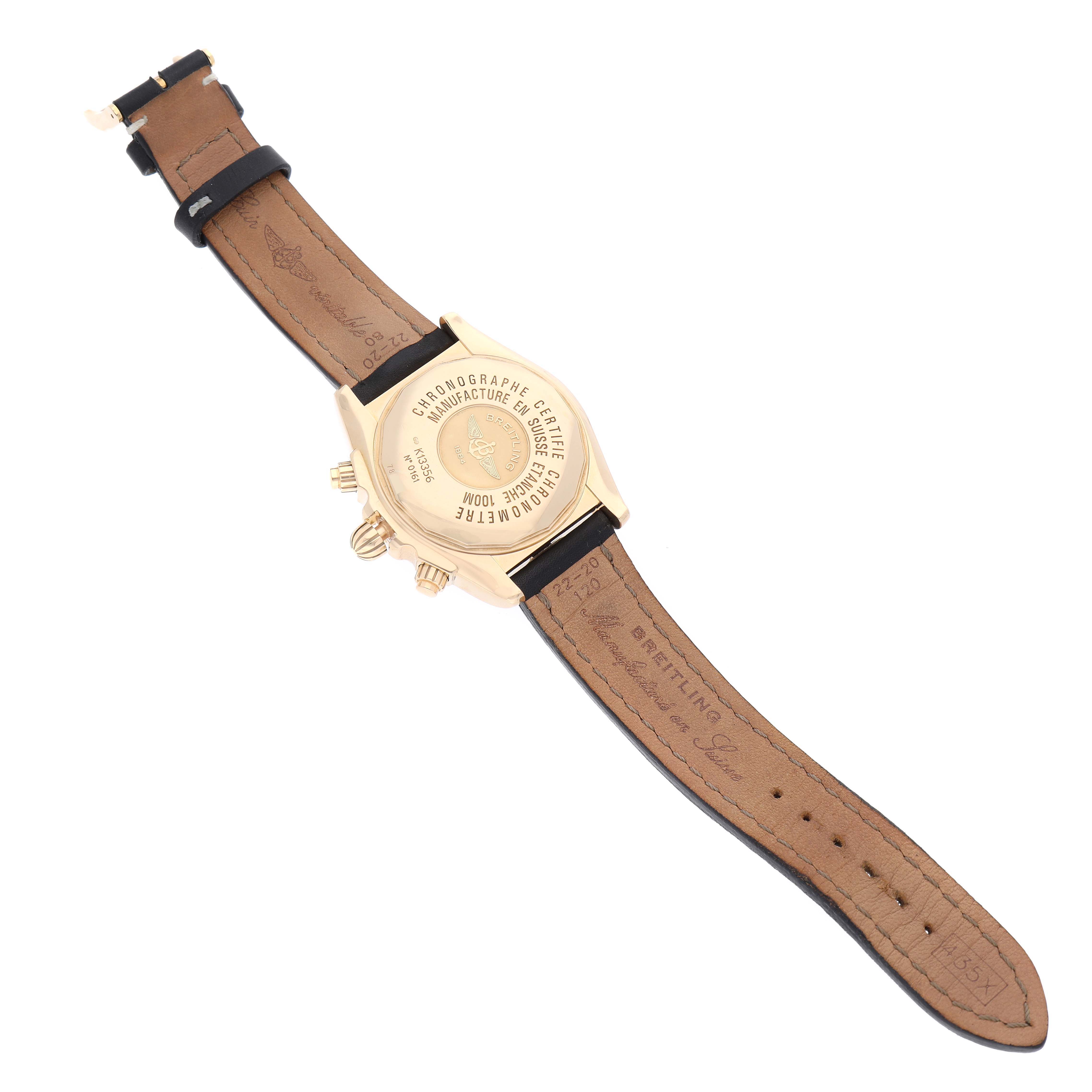 The image shows the back case and leather strap of a Breitling Chronomat K13356 Men
s Yellow Gold Black Dial K13356 Men
s Yellow Gold Black Dial watch, displaying the inscription and clasp.