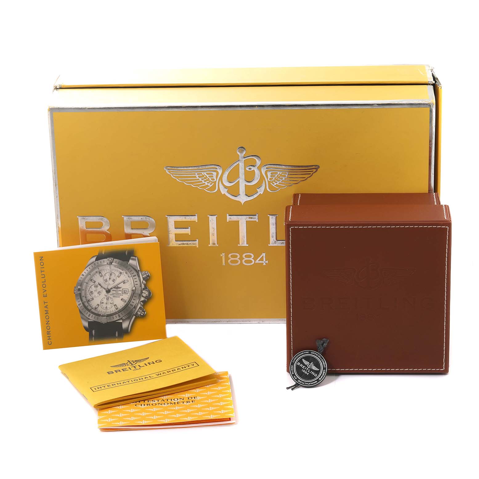 The image shows the packaging, manuals, warranty, and a tag for a Breitling Chronomat K13356 Men
s Yellow Gold Black Dial K13356 Men
s Yellow Gold Black Dial watch.