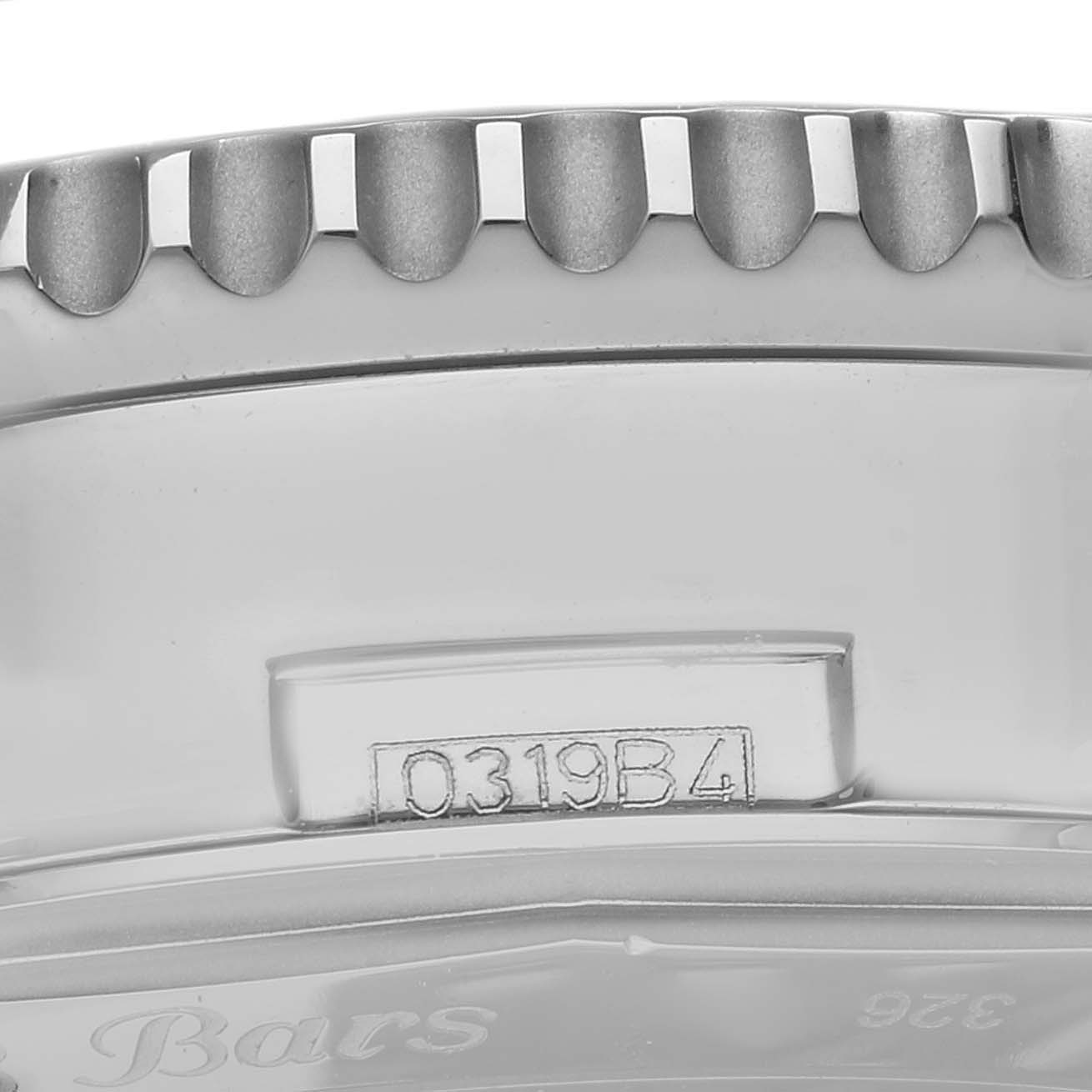 The image shows a close-up of the bezel and case side of a Breitling Navitimer AB0127 Men's Stainless Steel Blue Dial AB0127 Men's Stainless Steel Blue Dial watch, highlighting its serial number and grooves.