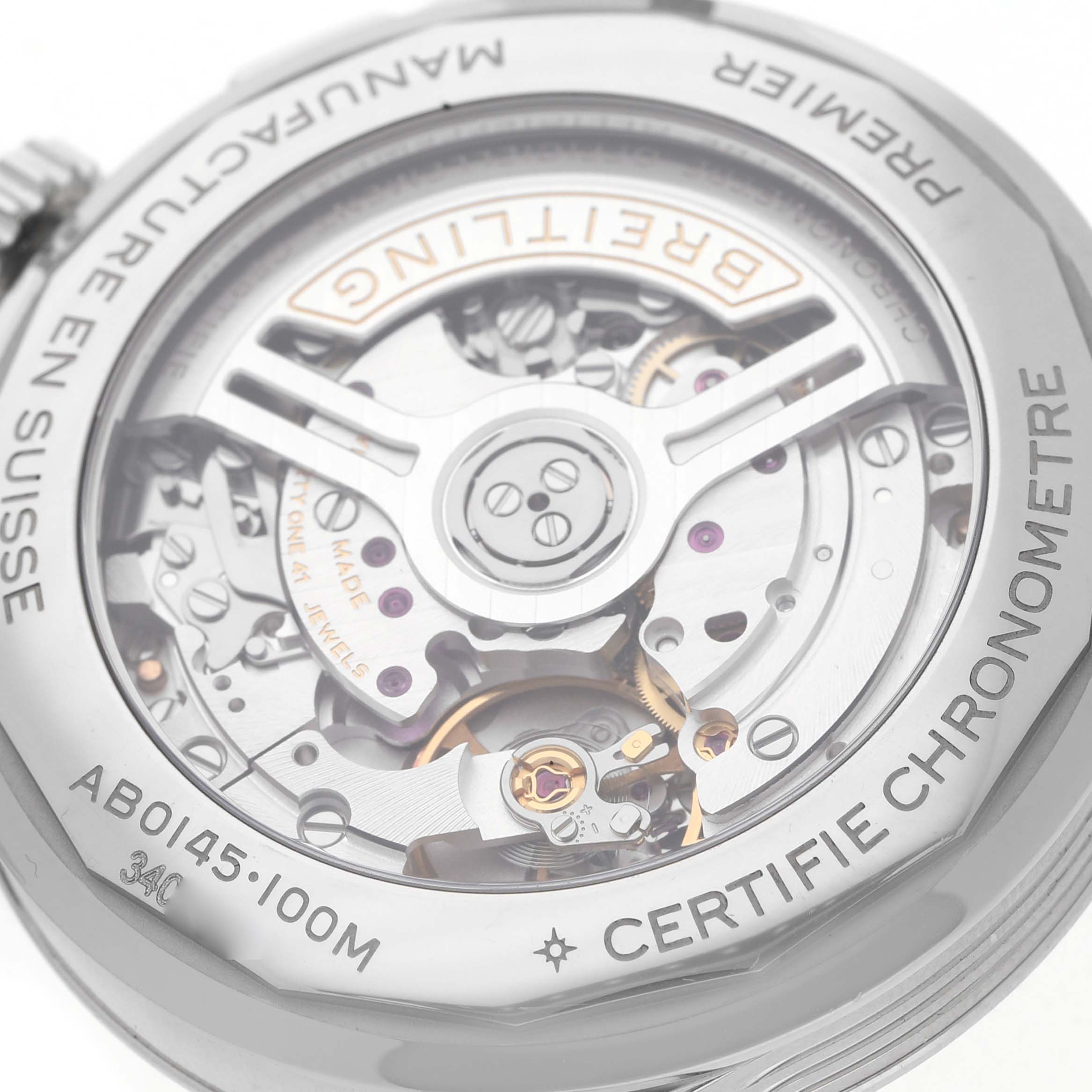 The image shows the exposed case back of a Breitling Premier AB0145 Men's Stainless Steel Orange Dial watch, highlighting the movement and rotor.