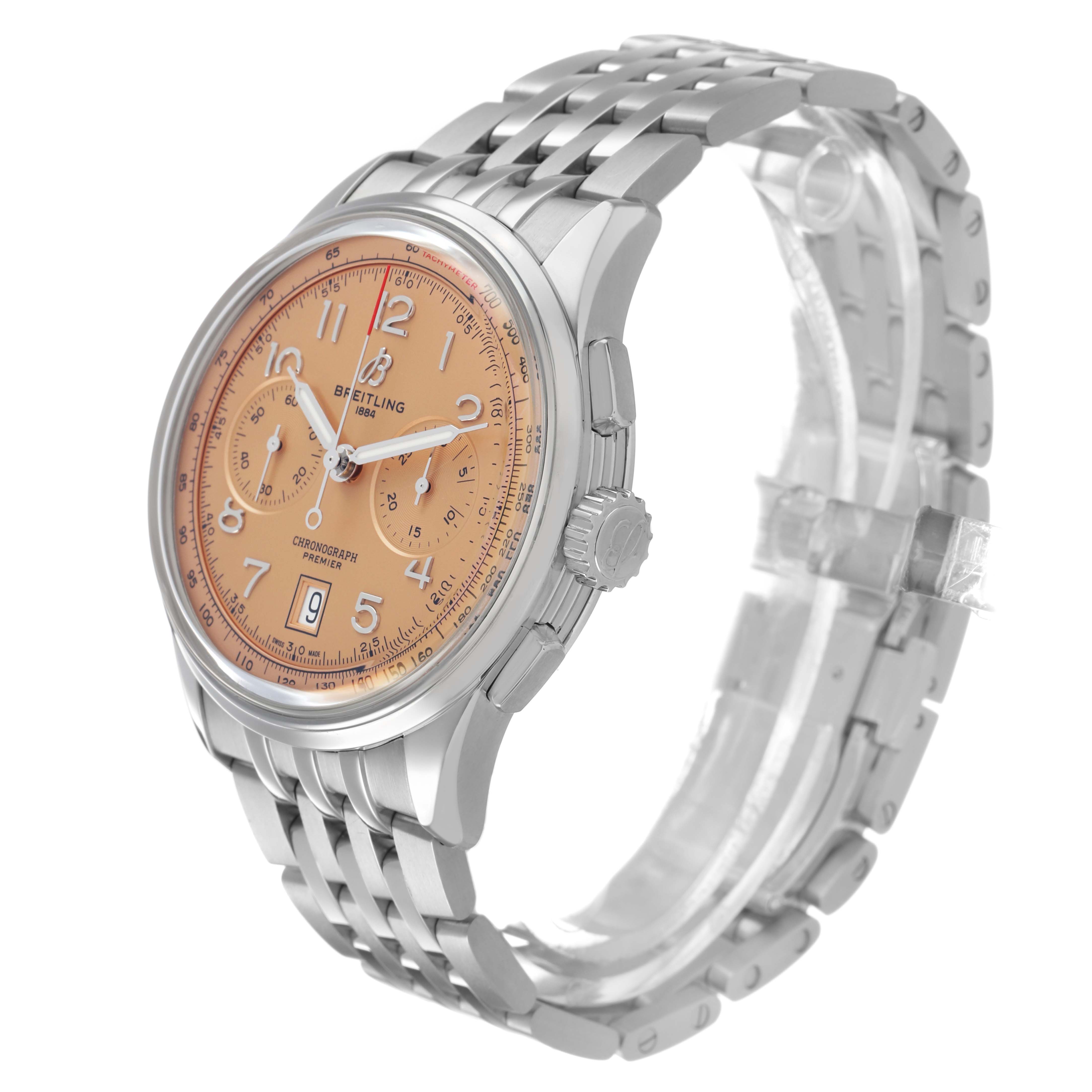 The Breitling Premier AB0145 Men's Stainless Steel Orange Dial watch is shown at a three-quarter angle, highlighting the face, bezel, crown, and metal bracelet.