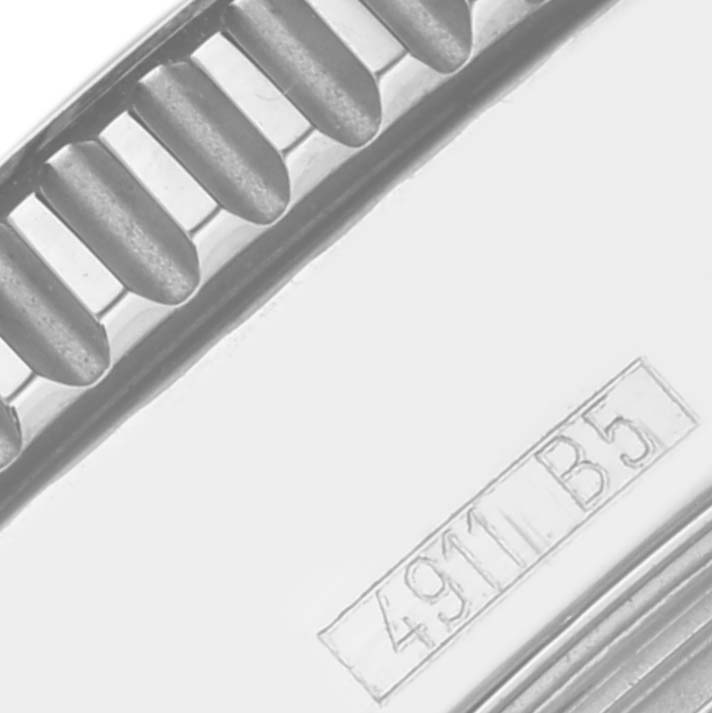 The image shows a close-up of the edge of a Breitling Superocean A17364 Men's Stainless Steel Black Dial A17364 Men's Stainless Steel Black Dial watch, displaying part of the bezel and serial number.