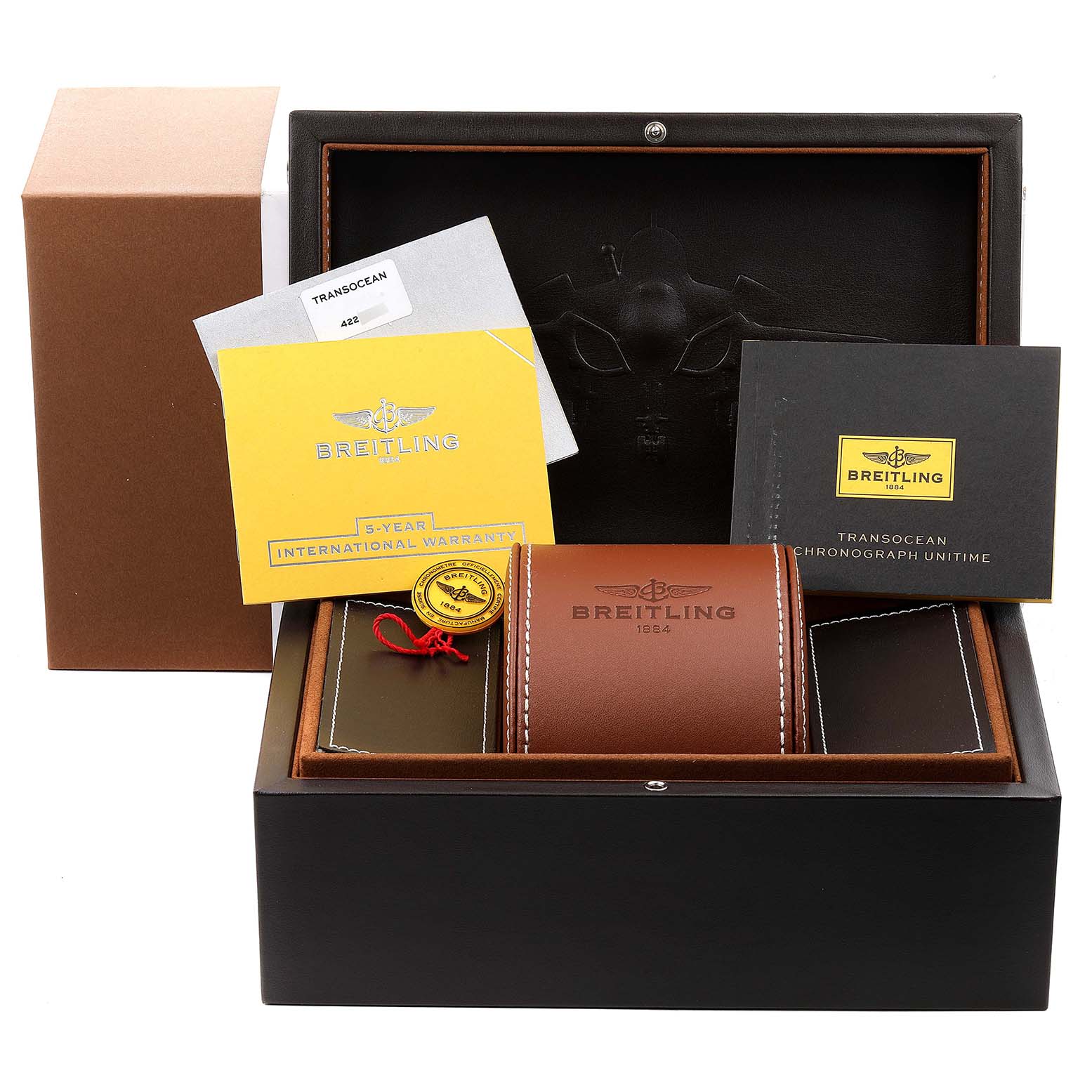 The image shows the packaging and accessories of a Breitling Transocean RB0510U4-BB63BKLD Men's Rose Gold White Dial RB0510U4-BB63BKLD Men's Rose Gold White Dial model, including a leather case, warranty card, and booklets.