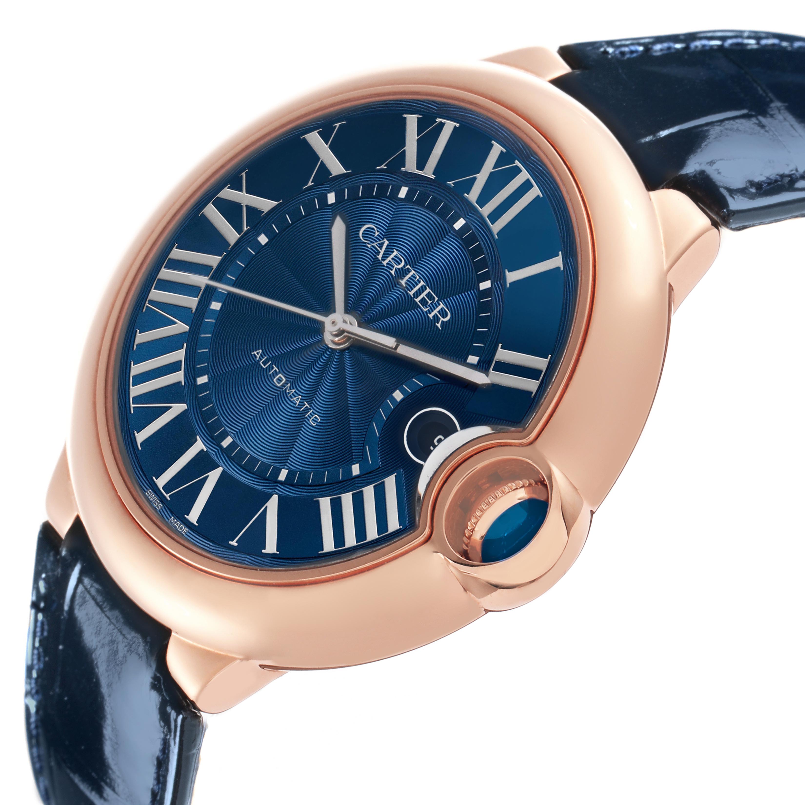 The Cartier Ballon Bleu WGBB0036 Men's Rose Gold Blue Dial WGBB0036 Men's Rose Gold Blue Dial watch is shown at a slight angle, highlighting the blue dial, rose gold case, and crown with a blue cabochon.