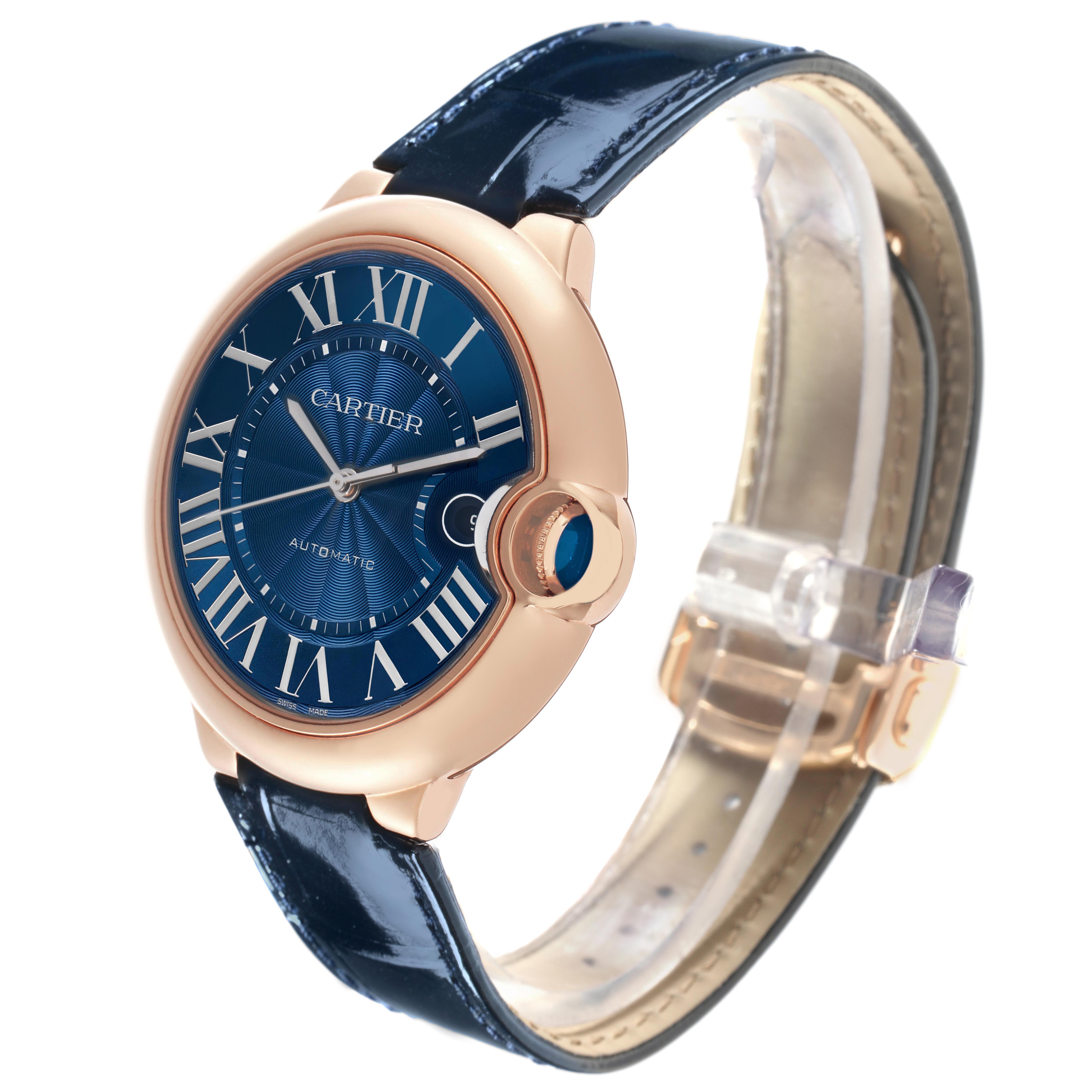 The Cartier Ballon Bleu WGBB0036 Men's Rose Gold Blue Dial watch is shown at a slight angle, revealing the blue dial, Roman numerals, crown, and leather strap.