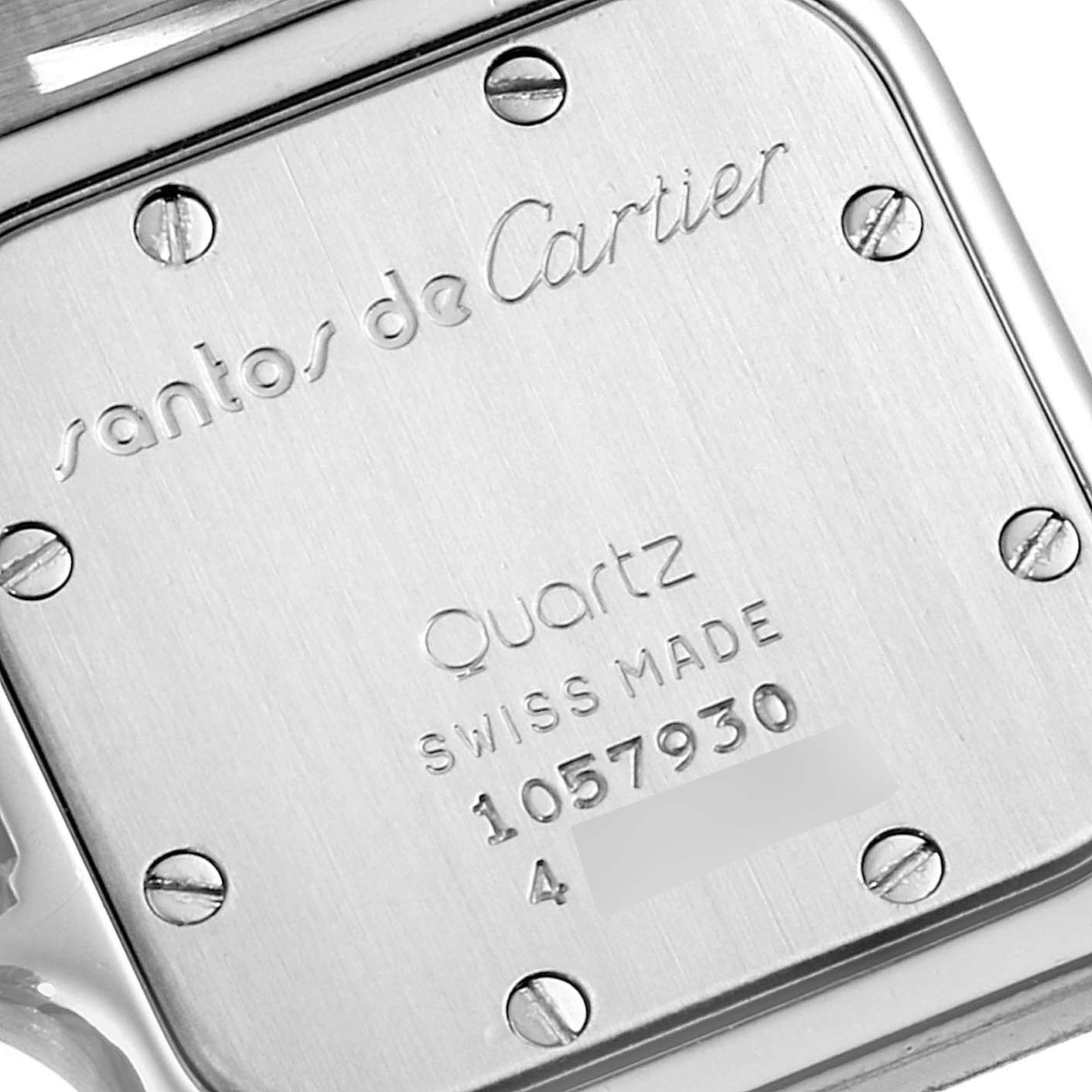 The image shows the back case of a Santos model by Cartier, featuring inscriptions and screws.