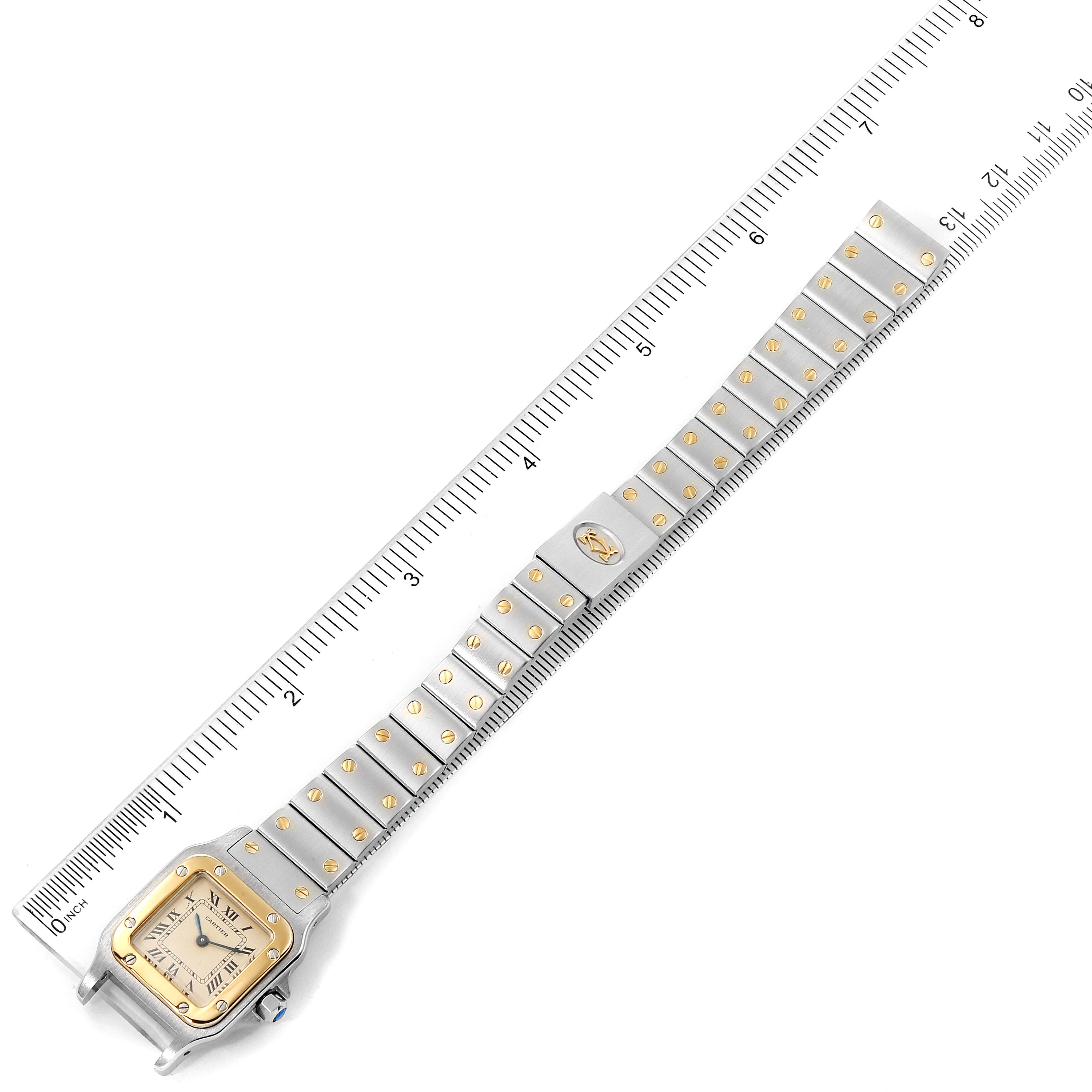 This image shows a top view of a Cartier Santos W20012C4 Women's Steel and Gold (two tone) Silver Dial W20012C4 Women's Steel and Gold (two tone) Silver Dial watch, displaying its face, bezel, and metal bracelet with gold screws.