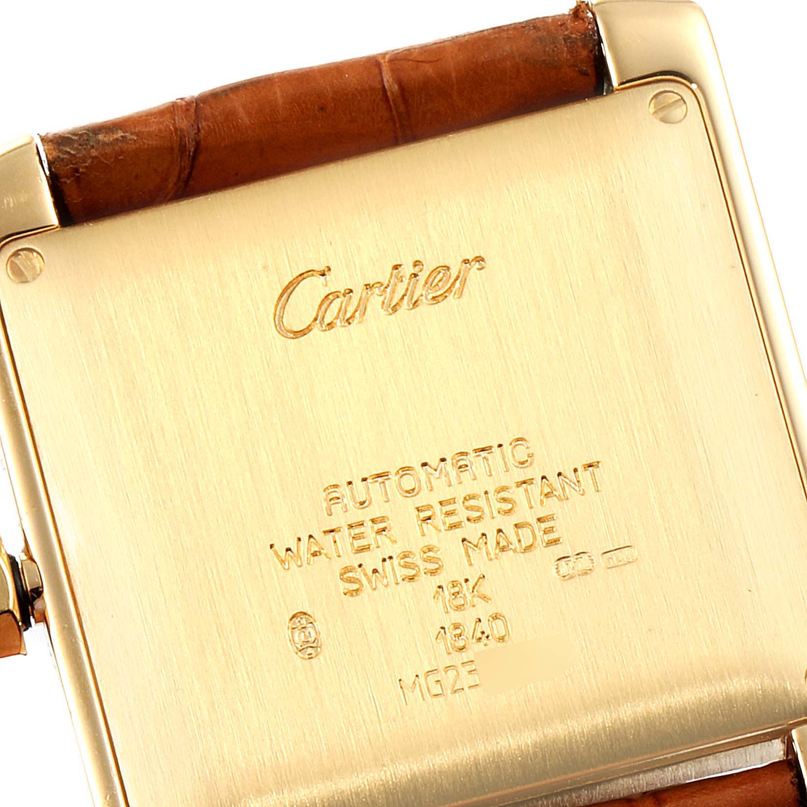 The image shows the backside of a Cartier Tank Francaise W5000156 Men's Yellow Gold Silver Dial W5000156 Men's Yellow Gold Silver Dial watch, highlighting the engravings and strap attachment.