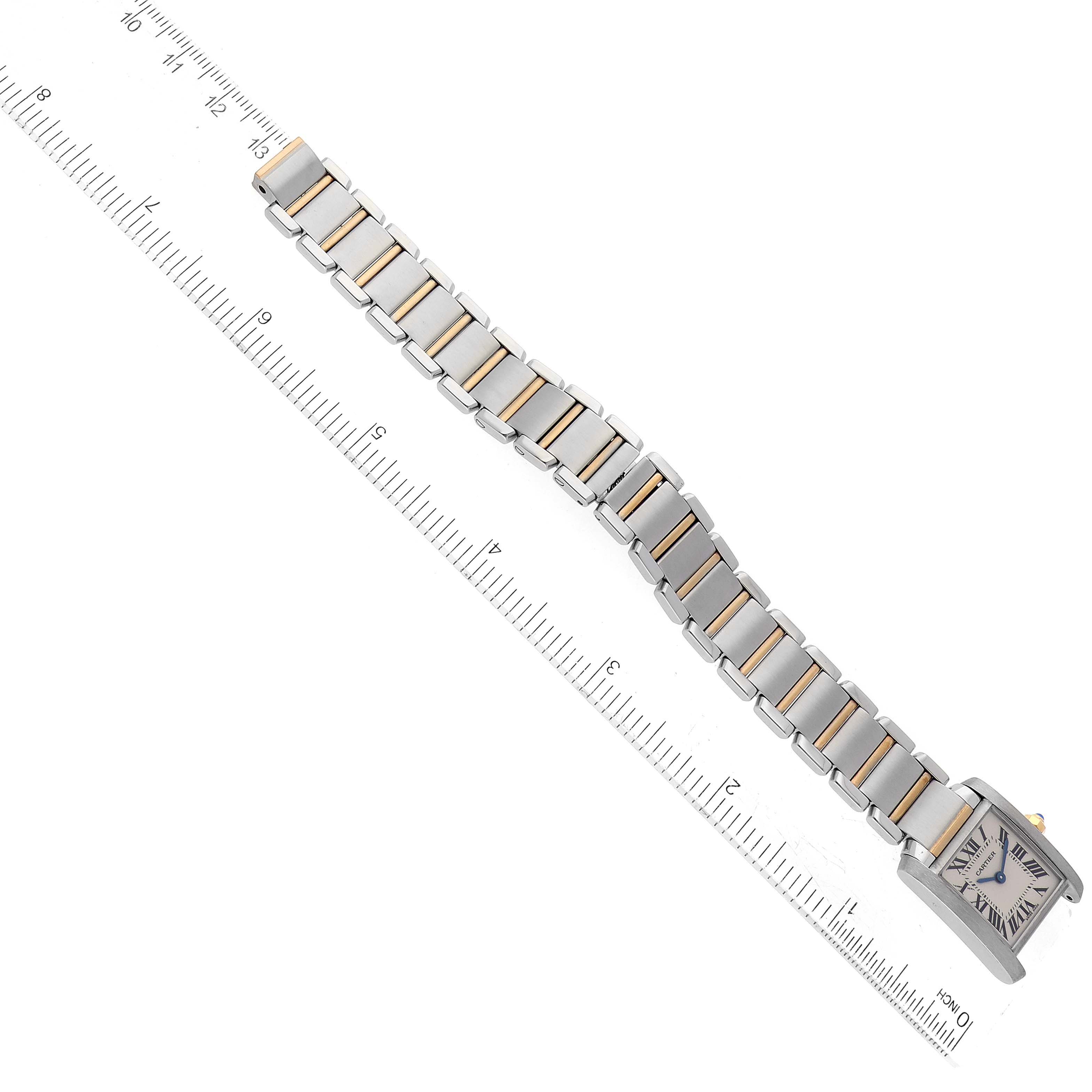 The Cartier Tank Francaise W51007Q4 Women
s Steel and Gold (two tone) Silver Dial W51007Q4 Women
s Steel and Gold (two tone) Silver Dial watch is shown in a top view alongside a ruler, displaying its face, bezel, and bracelet.