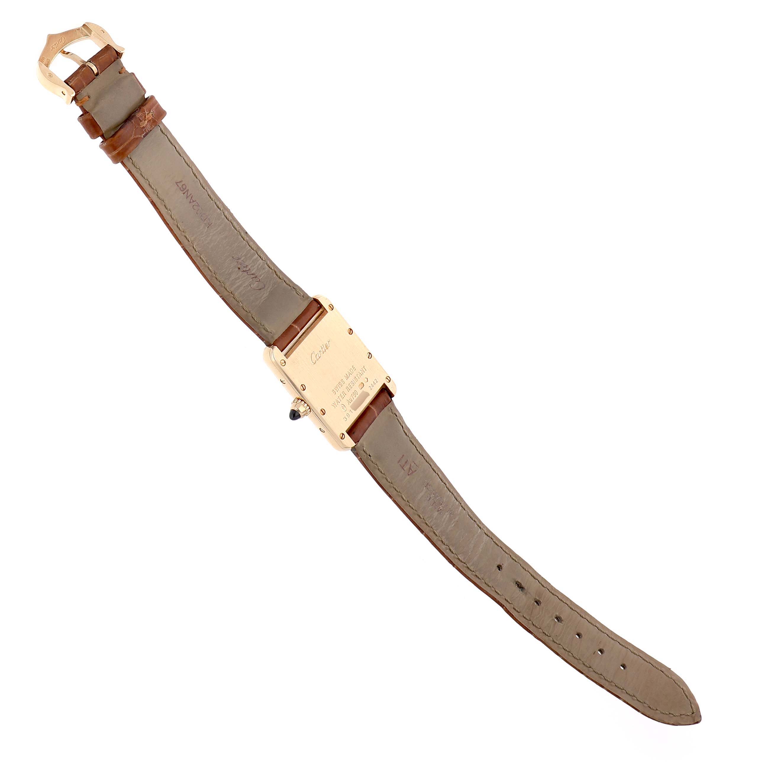 The Cartier Tank Louis W1529856 Women's Yellow Gold Silver Dial watch is shown from the back, displaying the leather strap and clasp.