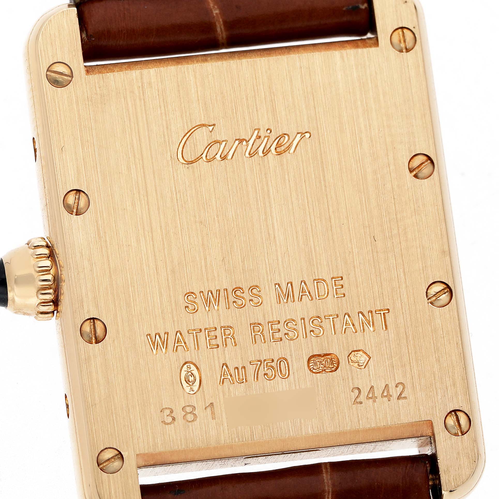 The image shows the back of the Cartier Tank Louis W1529856 Women's Yellow Gold Silver Dial watch, featuring engravings and part of the leather strap.