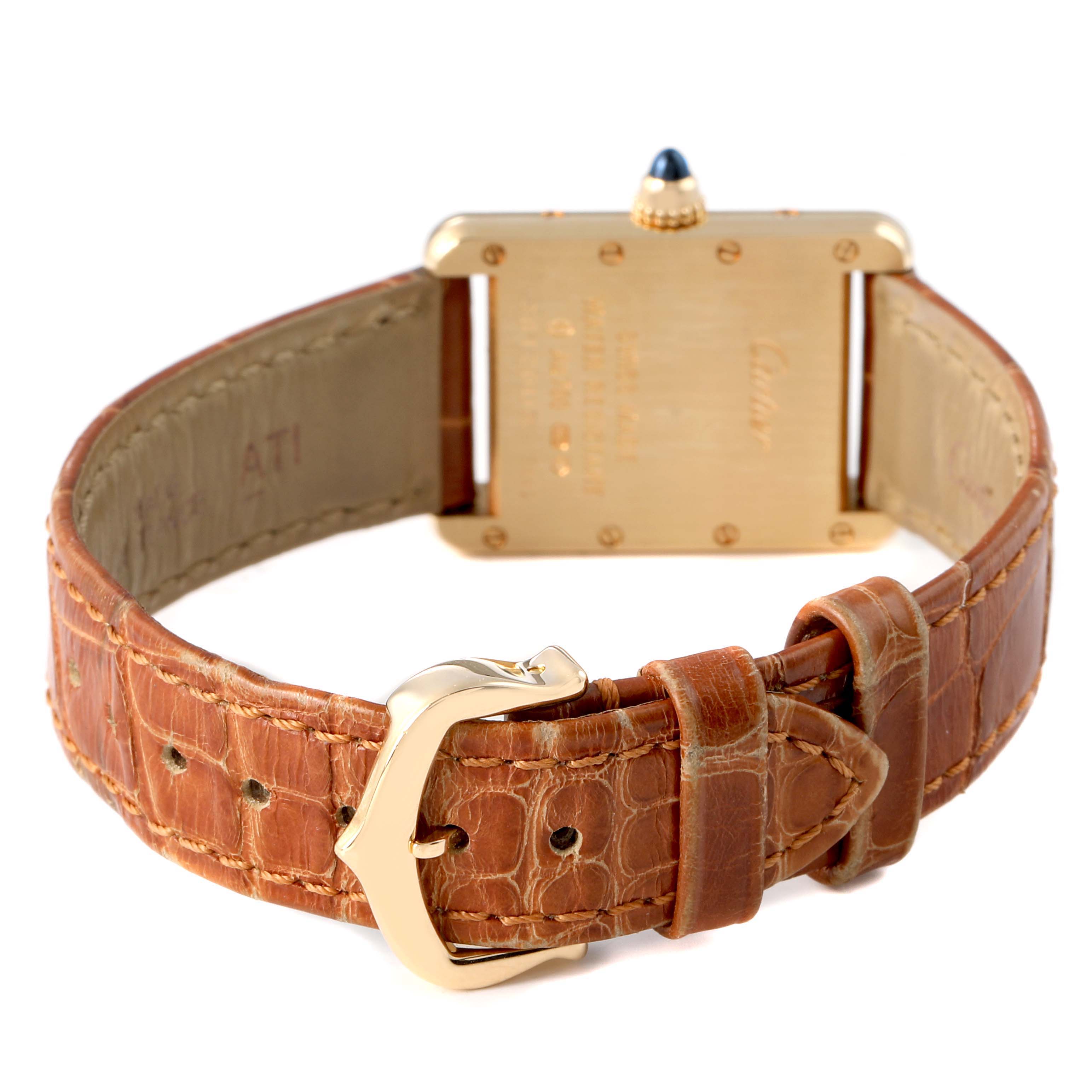 The image shows the back and buckle of a Cartier Tank Louis W1529856 Women's Yellow Gold Silver Dial watch, highlighting the gold case and brown leather strap.