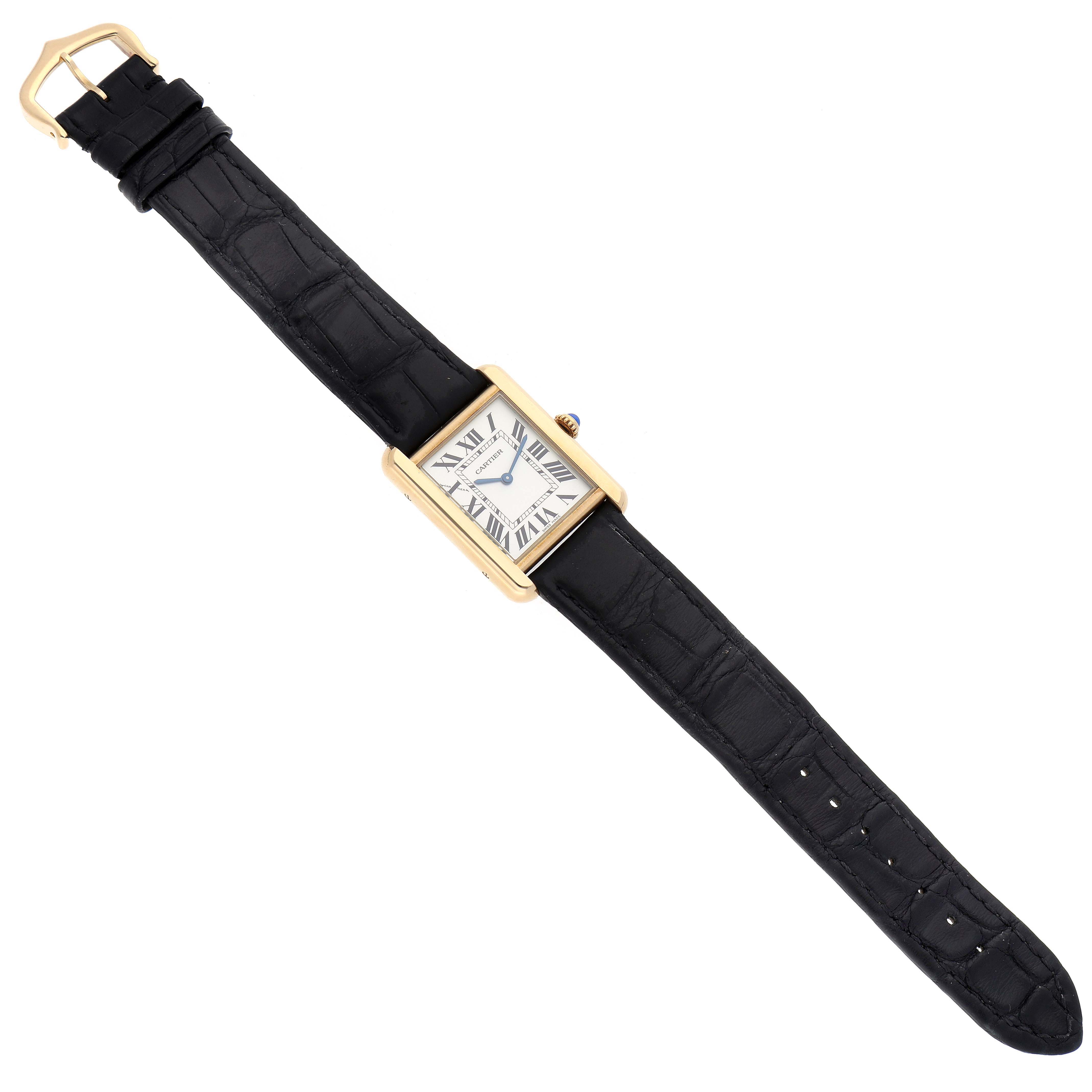The Cartier Tank Solo W5200002 Women's Steel and Gold (two tone) Silver Dial W5200002 Women's Steel and Gold (two tone) Silver Dial watch is shown from a top-down angle, displaying the entire black leather strap, gold rectangular case, and dial.