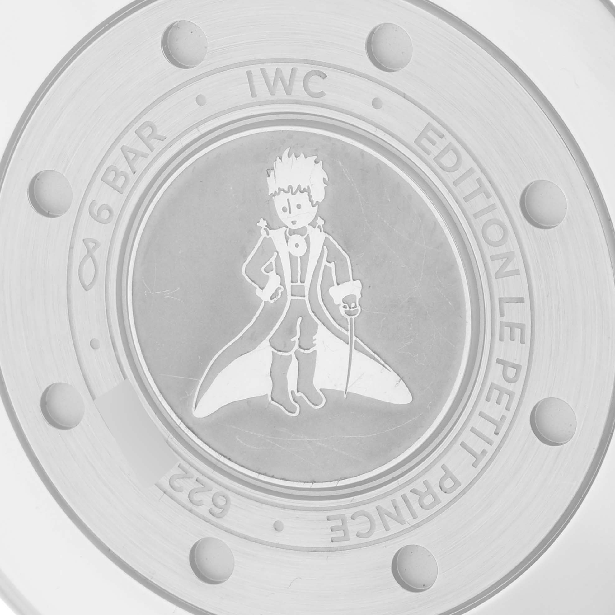 The image shows the engraved case back of the IWC Pilot IW501002 Men's Stainless Steel Blue Dial IW501002 Men's Stainless Steel Blue Dial "Le Petit Prince" edition watch.