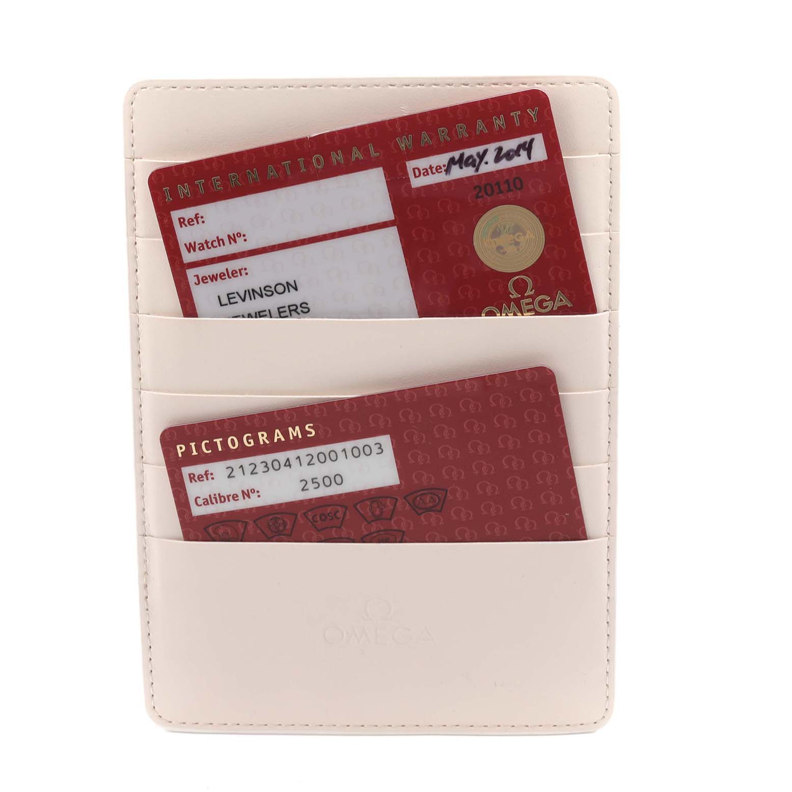 The image shows warranty cards for the Omega Seamaster 212.30.41.20.01.003 Men
s Stainless Steel Black Dial 212.30.41.20.01.003 Men
s Stainless Steel Black Dial, stored in a cream-colored holder.