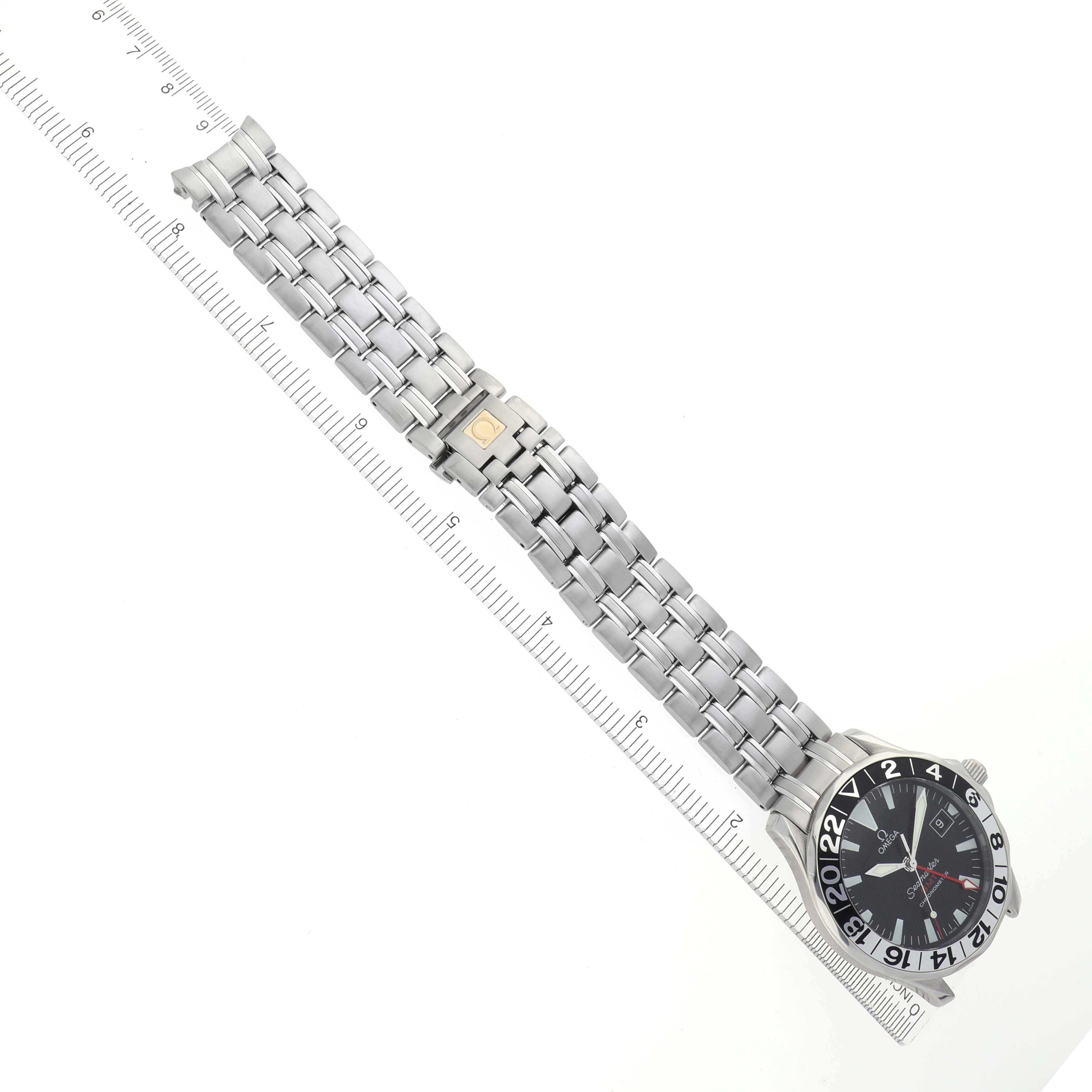 The Omega Seamaster 2534.50.00 Men
s Stainless Steel Black Dial 2534.50.00 Men
s Stainless Steel Black Dial watch is shown from a top angle, highlighting the face, bezel, and bracelet alongside a ruler for scale.