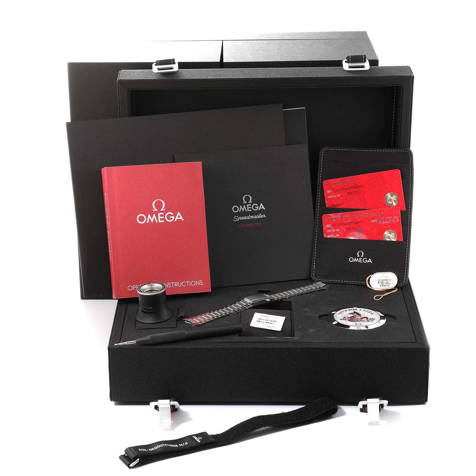 The image shows the packaging and accessories of an Omega Speedmaster 311.30.40.30.01.001 Men
s Stainless Steel Black Dial 311.30.40.30.01.001 Men
s Stainless Steel Black Dial watch including manuals, cards, a strap, and tools in an open box.