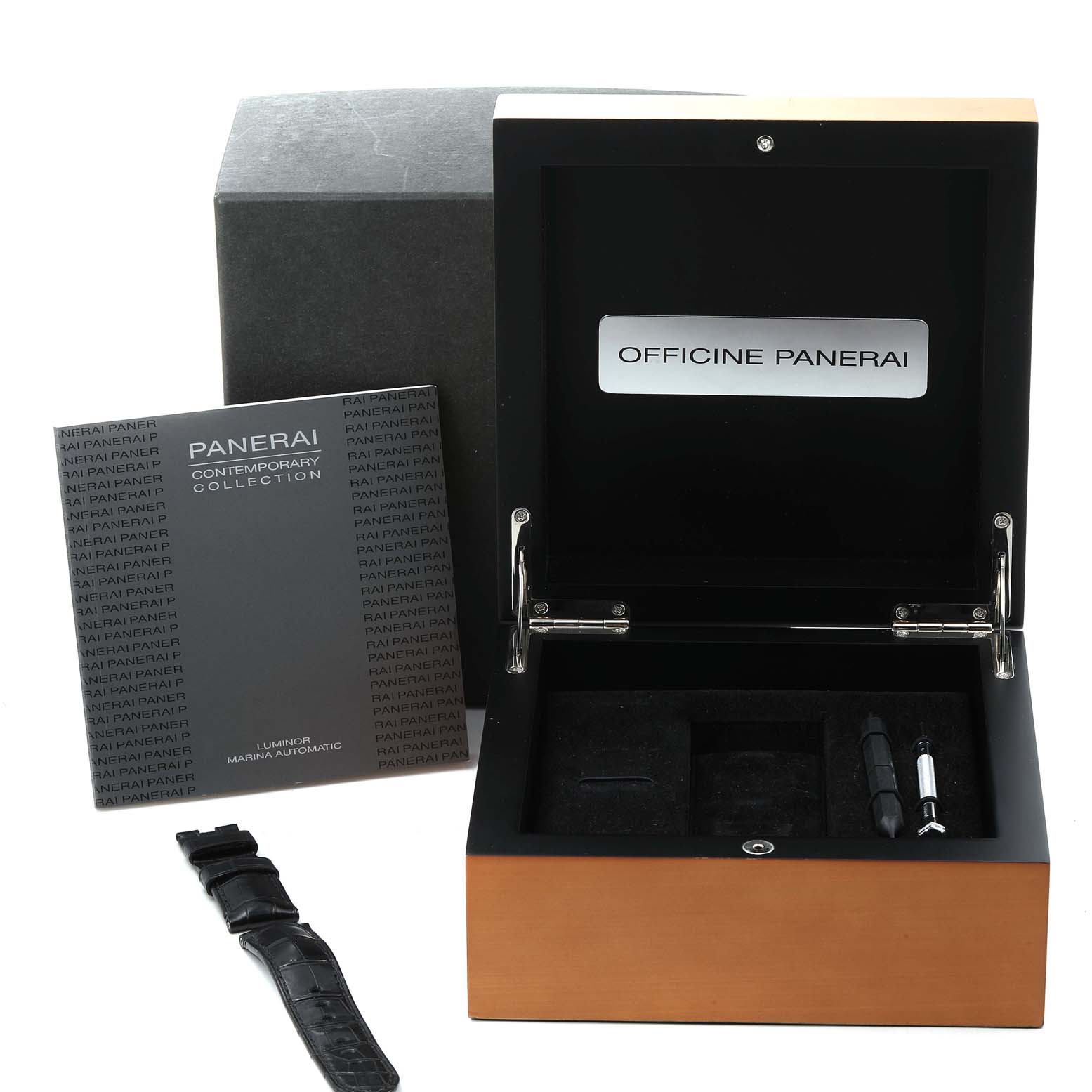 The image shows a Panerai Luminor PAM00104 Men
s Stainless Steel Black Dial PAM00104 Men
s Stainless Steel Black Dial watch box, booklet, strap, and tools from a front angle.