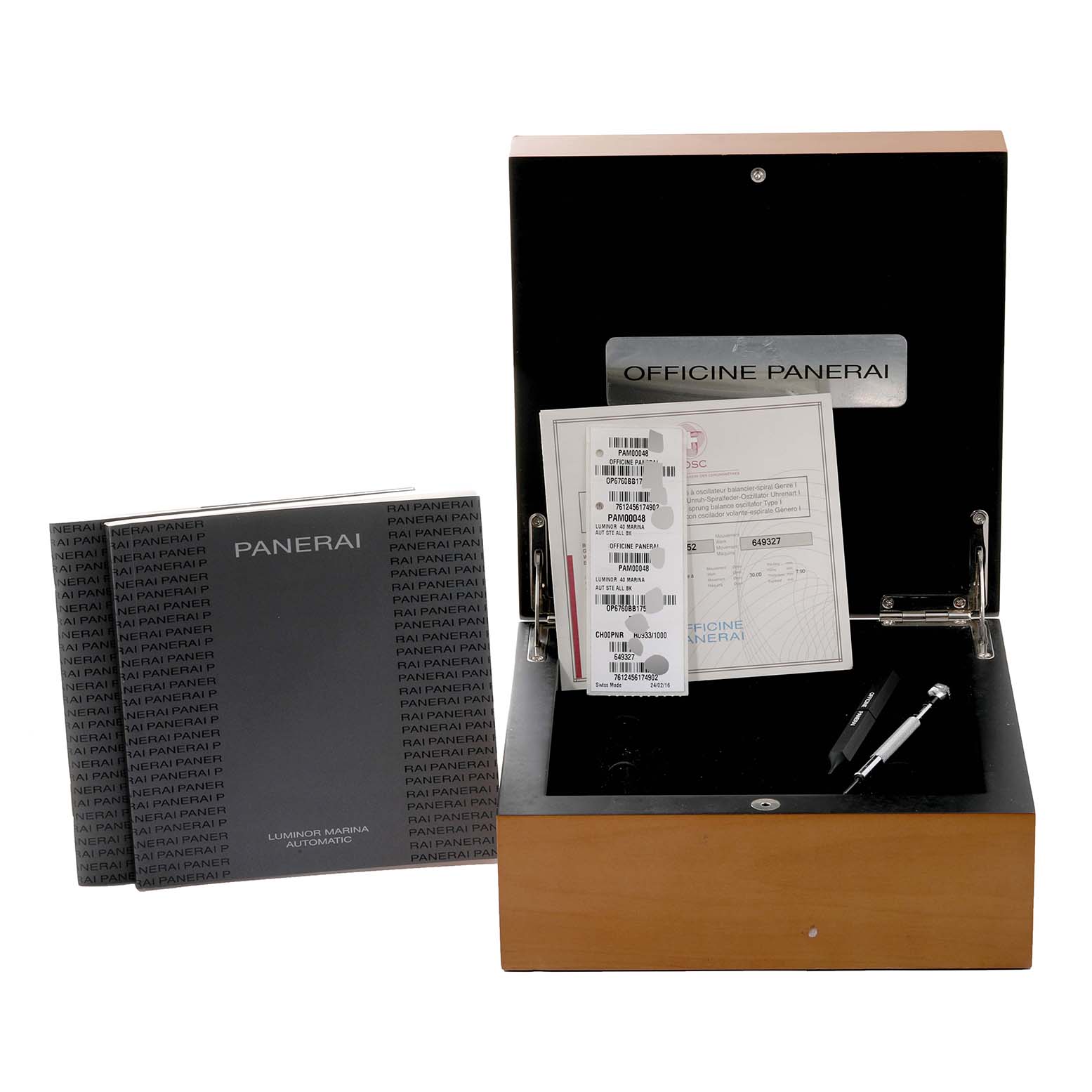 The image shows the open box, manuals, and accessories of a Panerai Luminor PAM00048 Men
s Stainless Steel Black Dial PAM00048 Men
s Stainless Steel Black Dial watch, including possibly a strap tool.