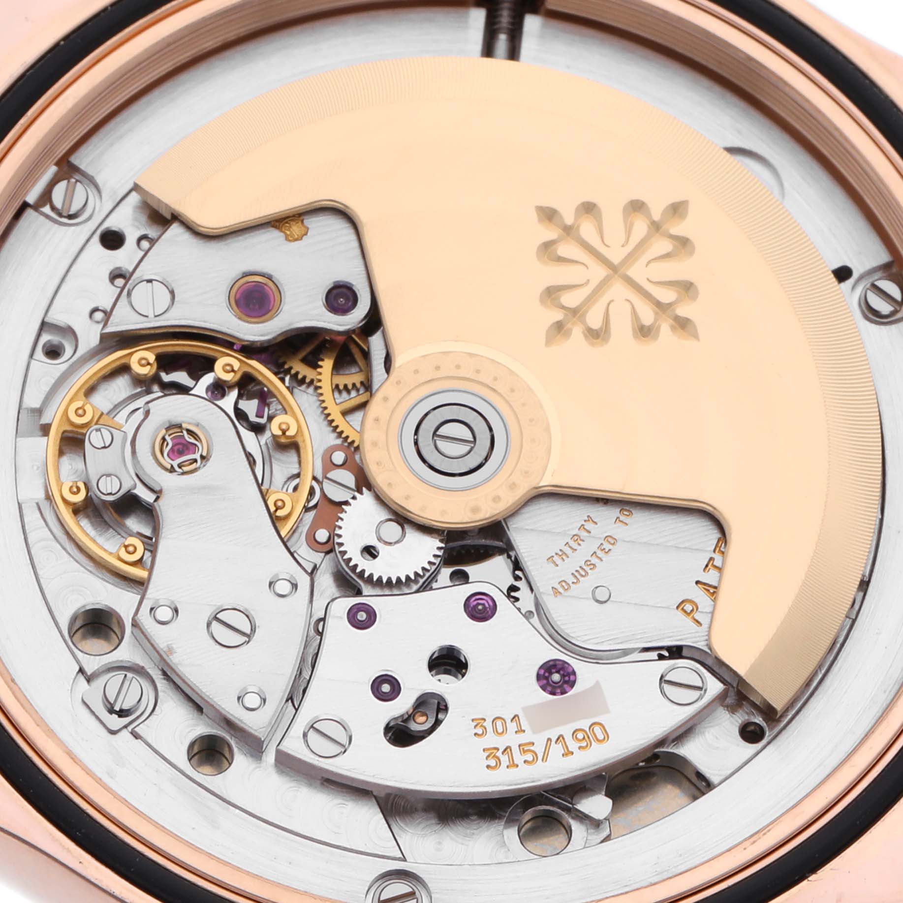 The image shows the back view of the Patek Philippe Calatrava 5107R Men's Rose Gold Silver Dial 5107R Men's Rose Gold Silver Dial, focusing on its intricate movement and rotor.