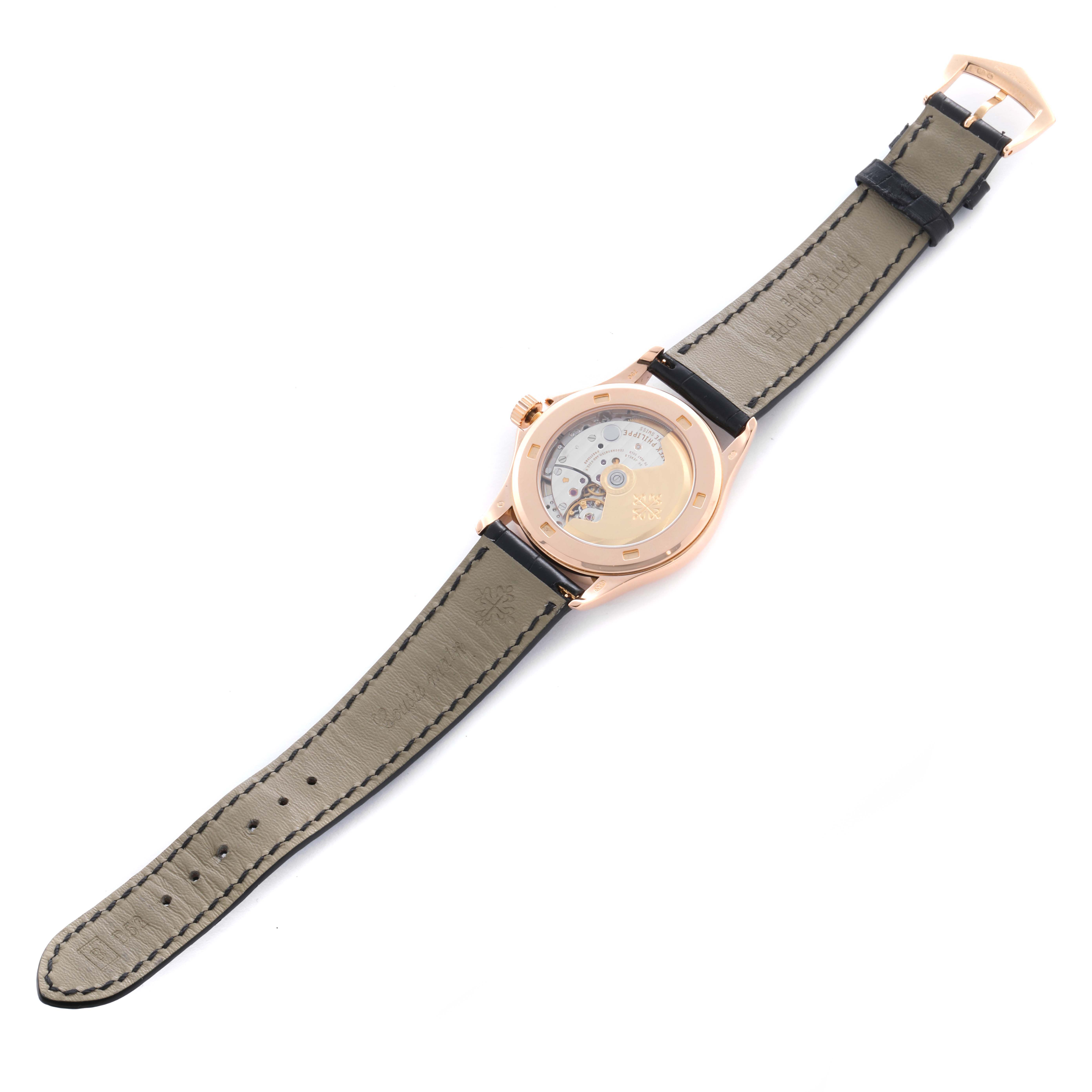 The Patek Philippe Calatrava 5107R Men's Rose Gold Silver Dial 5107R Men's Rose Gold Silver Dial watch is shown from the back, highlighting its transparent case back and leather strap.