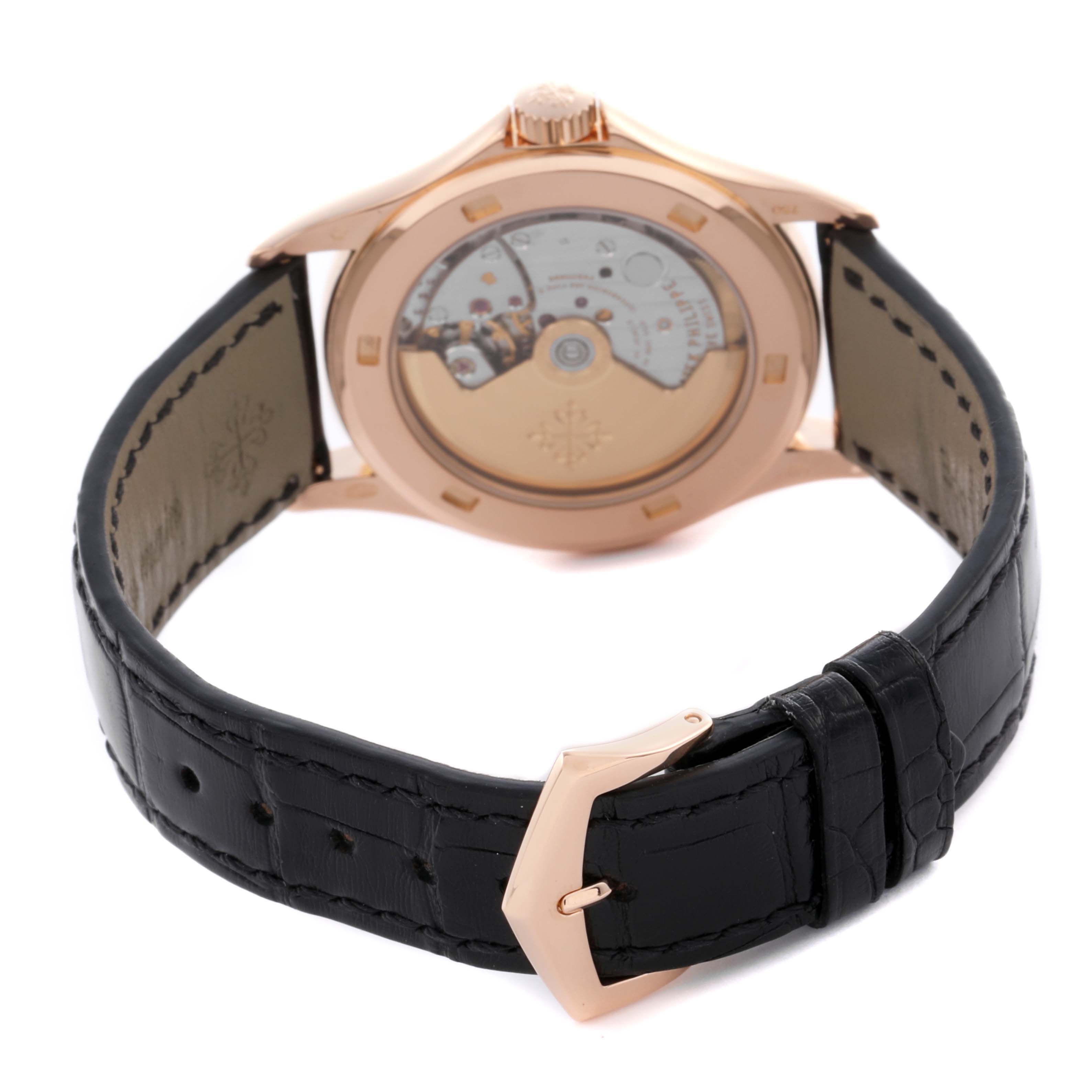 The image shows the back of a Patek Philippe Calatrava 5107R Men's Rose Gold Silver Dial 5107R Men's Rose Gold Silver Dial watch, showcasing the movement and a leather strap with a buckle.