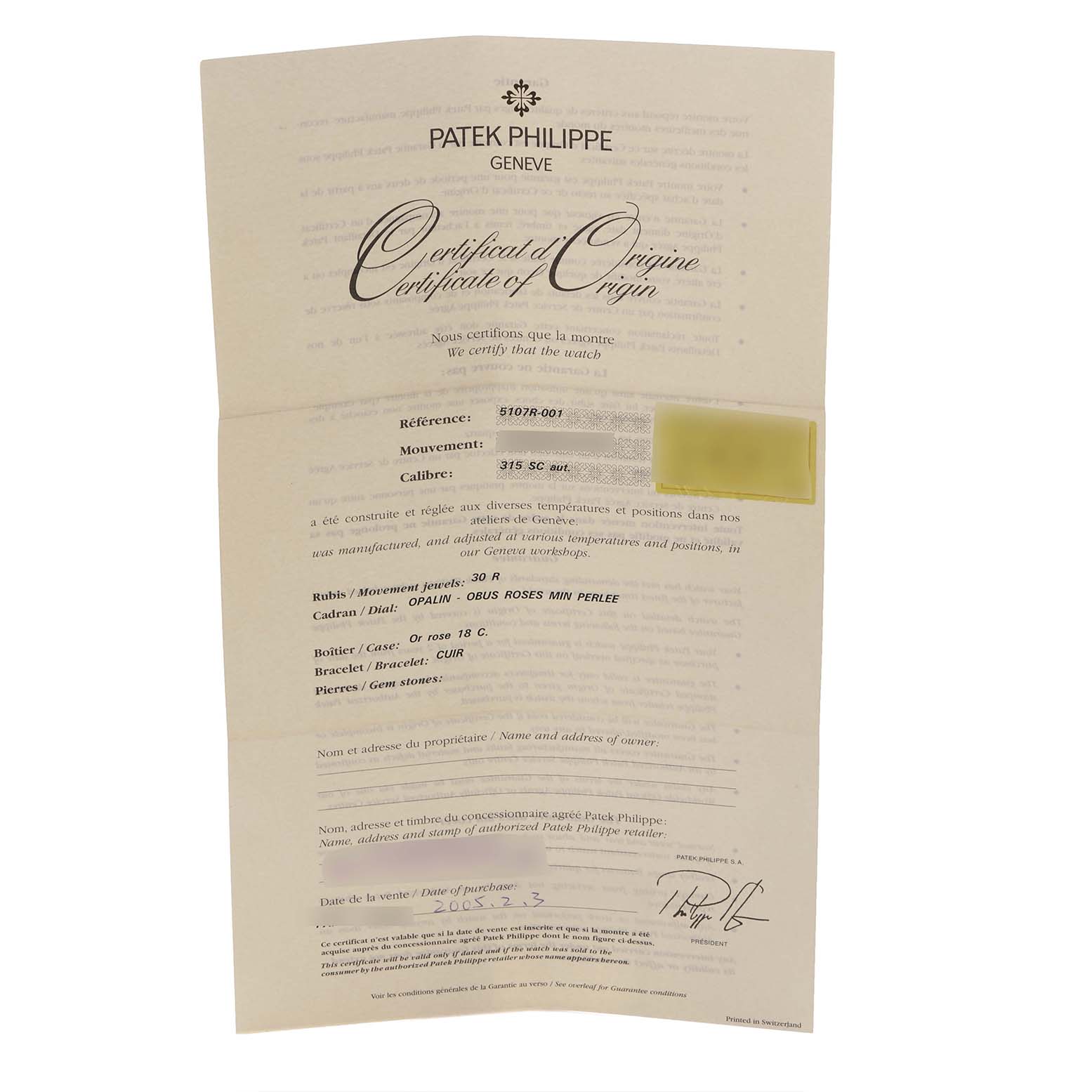 This image shows a Patek Philippe Calatrava 5107R Men's Rose Gold Silver Dial 5107R Men's Rose Gold Silver Dial Certificate of Origin document at a slight angle.