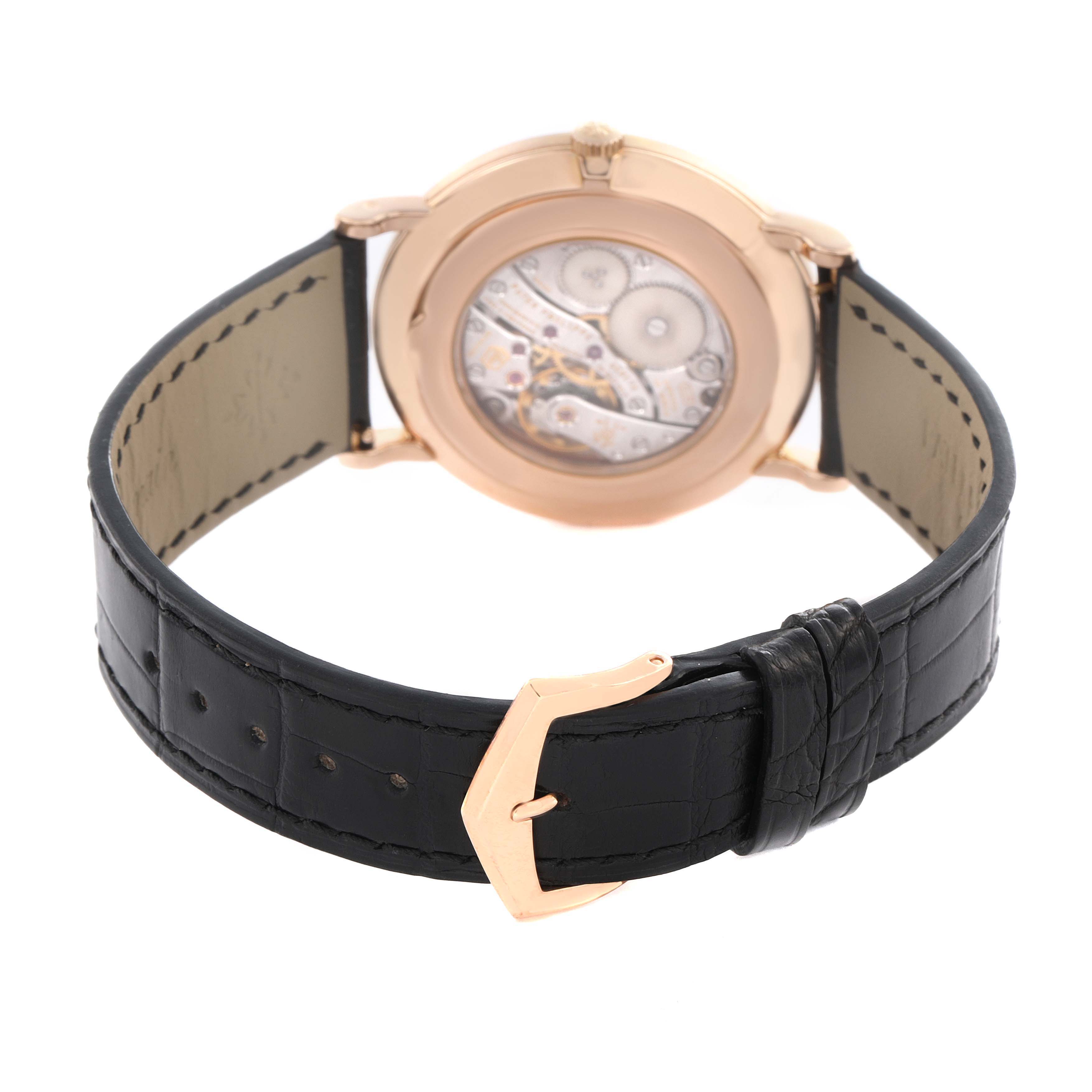 The image shows the back of the Patek Philippe Calatrava 5119R-001 Men's Rose Gold White Dial 5119R-001 Men's Rose Gold White Dial watch, highlighting the mechanical movement and black leather strap.