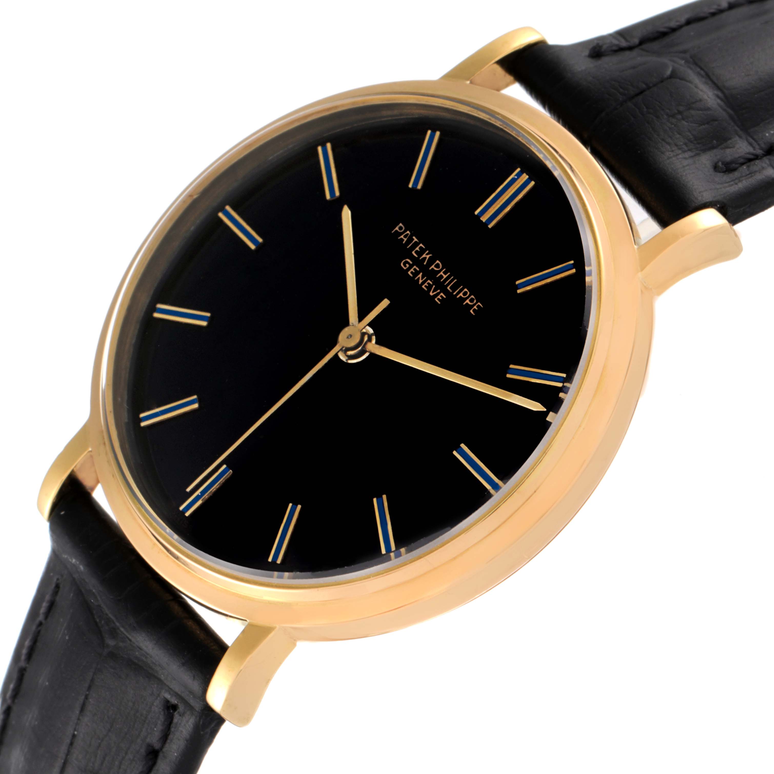 The image shows a side angle of a Patek Philippe Calatrava 3569 Men's Yellow Gold Black Dial 3569 Men's Yellow Gold Black Dial watch, highlighting its black dial, gold case, and black leather strap.