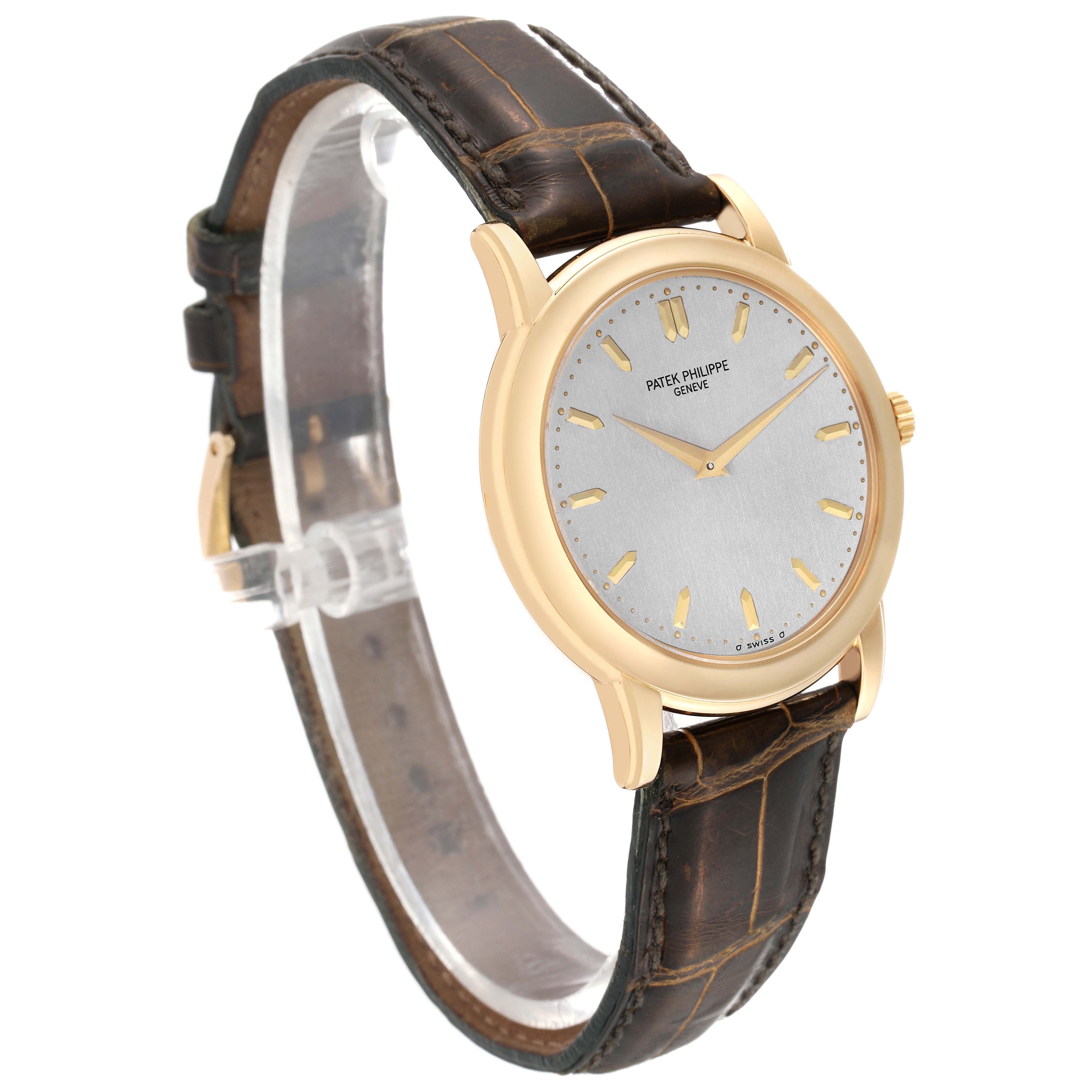 The Patek Philippe Calatrava 5032 Men's Yellow Gold Silver Dial watch is shown at a slight angle, displaying the dial, case, crown, and leather strap.