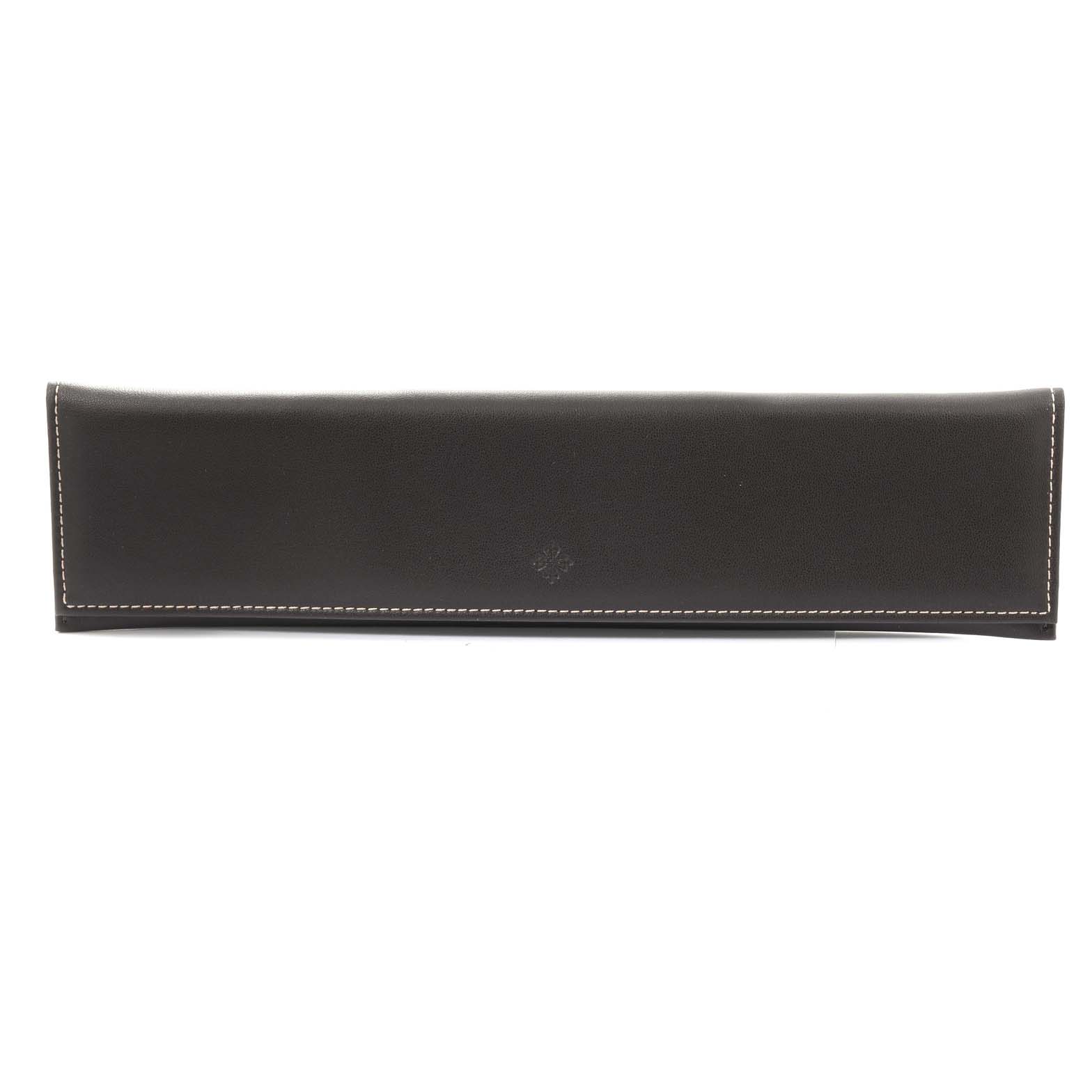The image shows a straight-on view of a black leather case designed for the Calatrava model by Patek Philippe.