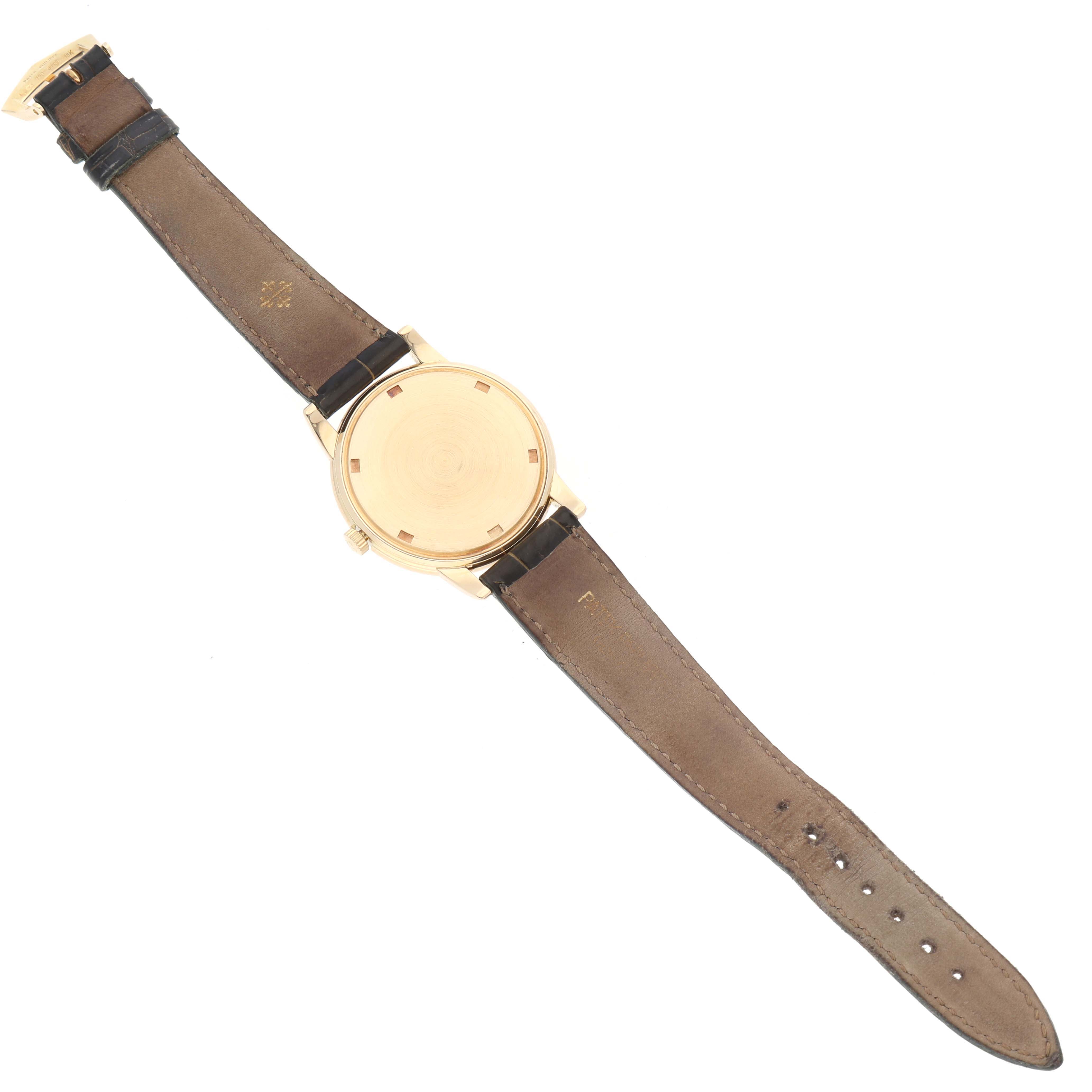 This image shows the back view of a Patek Philippe Calatrava 5032 Men's Yellow Gold Silver Dial 5032 Men's Yellow Gold Silver Dial watch, displaying its leather strap and closed case back.