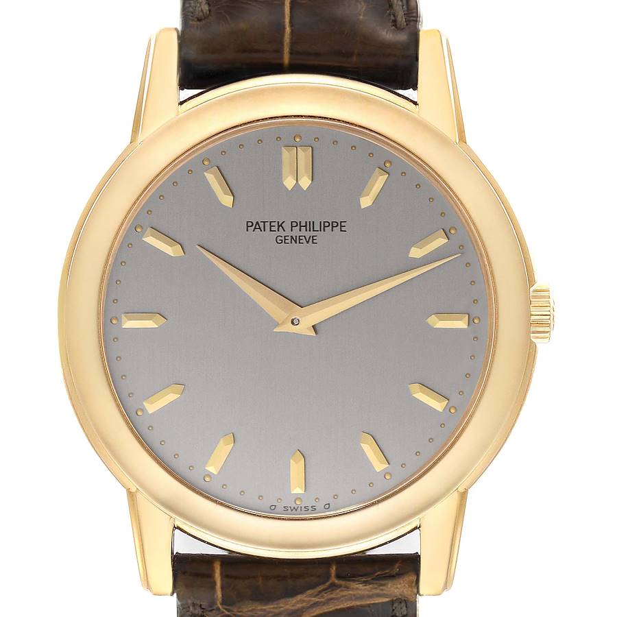 The image shows a frontal view of a Patek Philippe Calatrava watch, displaying its dial, hands, case, and partially the leather strap.