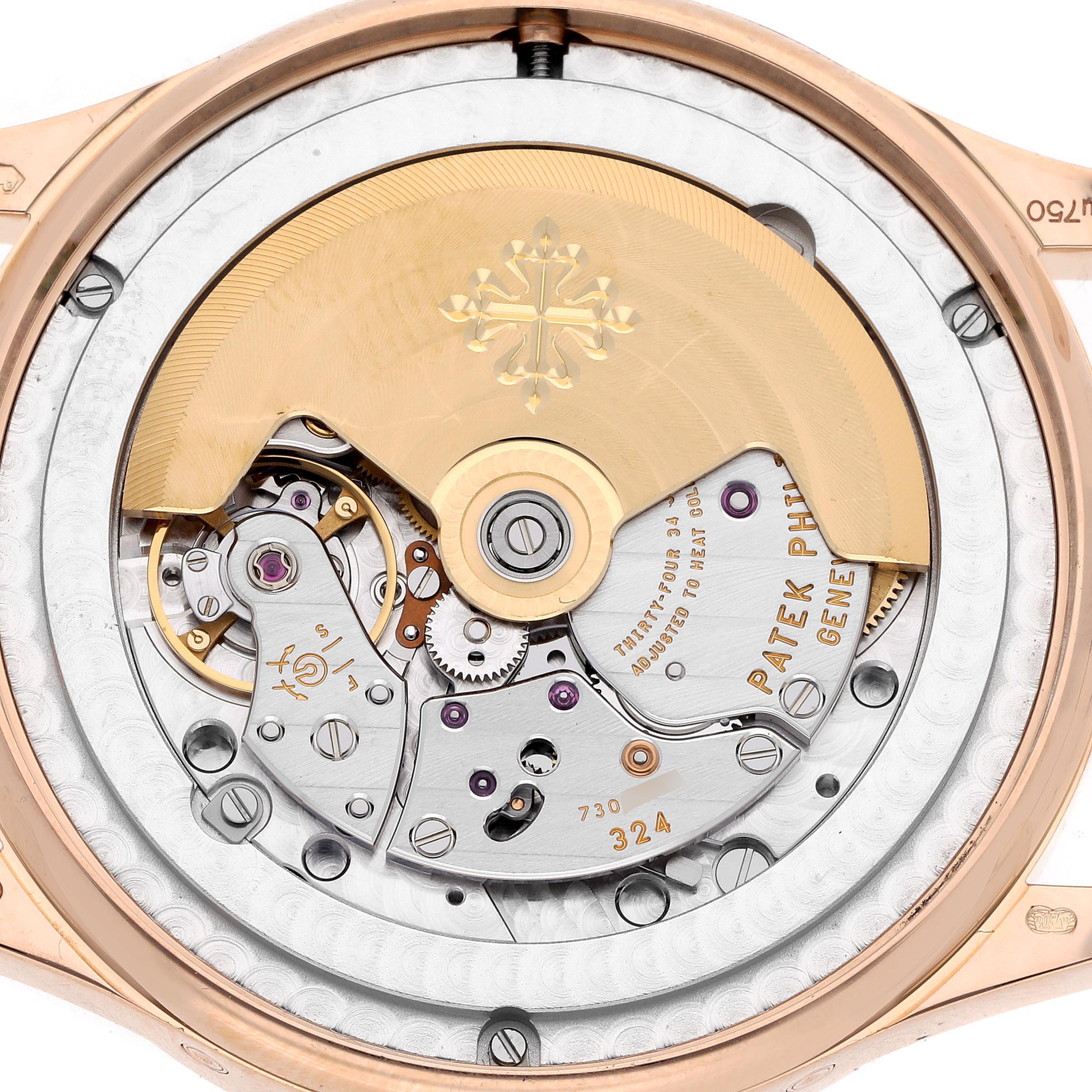 The image shows a close-up of the movement from the back angle of the Patek Philippe Complications 5396R-014 Men
s Rose Gold Blue Dial 5396R-014 Men
s Rose Gold Blue Dial watch, featuring its rotor and gears.